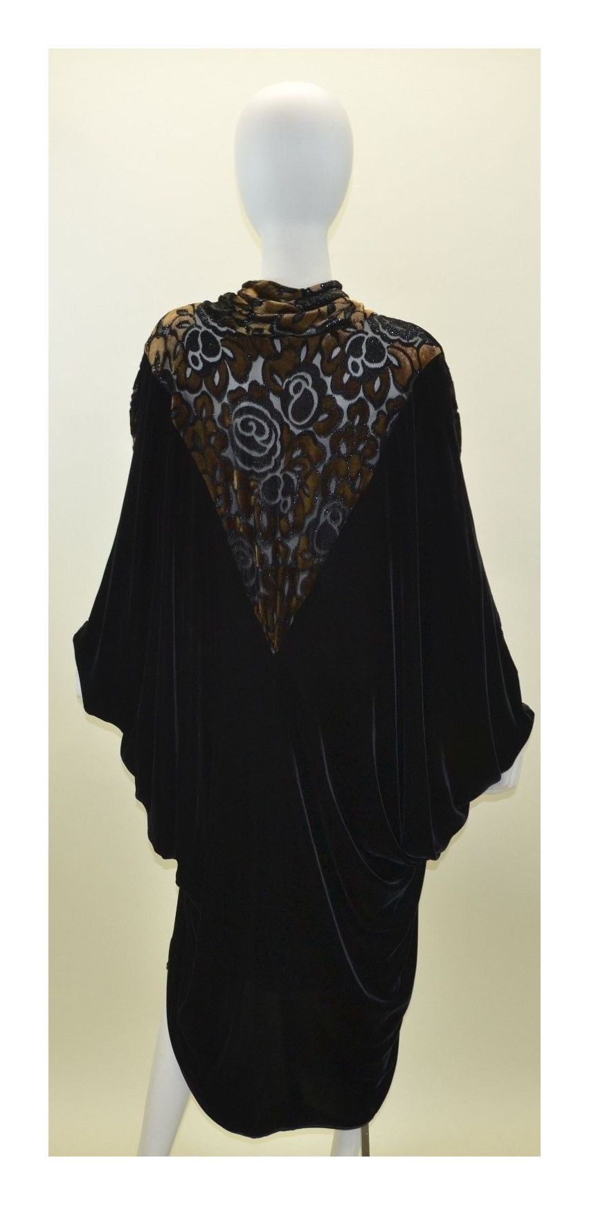 Vintage Janice Wainwright Dolman Batwin Sleeve Dress Caftan was made in England, size UK 12, 65% rayon, 27% silk, and 8% polyester, and a satin trim at the neck. Bronze/brown velvet detailing along the neckline and sleeves.

Measurements: 
Bust -