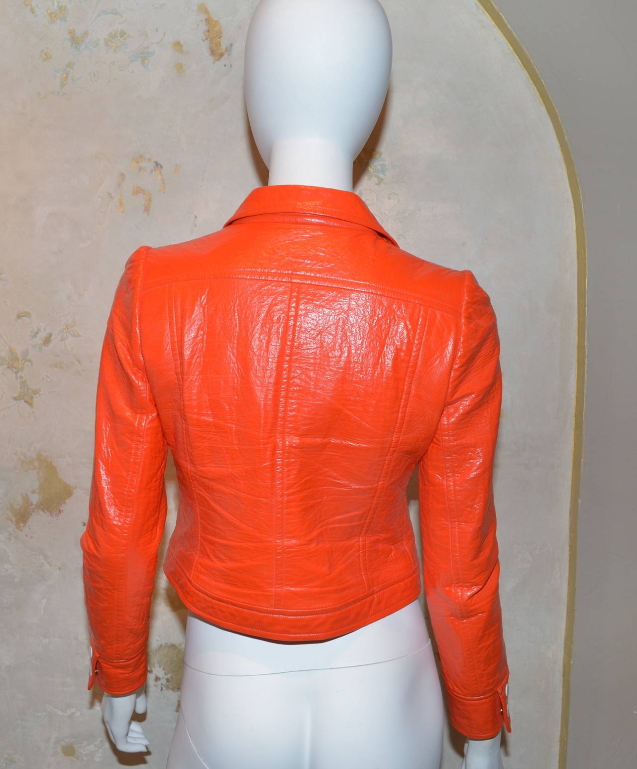 Courreges 1960's vinyl jacket features Large AC logo as seen on Sharon Stone in Casino. Snap-stud button closures along the front and on the cuffs as well. Original Courreges logo at the left bust. Jacket is made with 85% cotton and 15% spandex, and