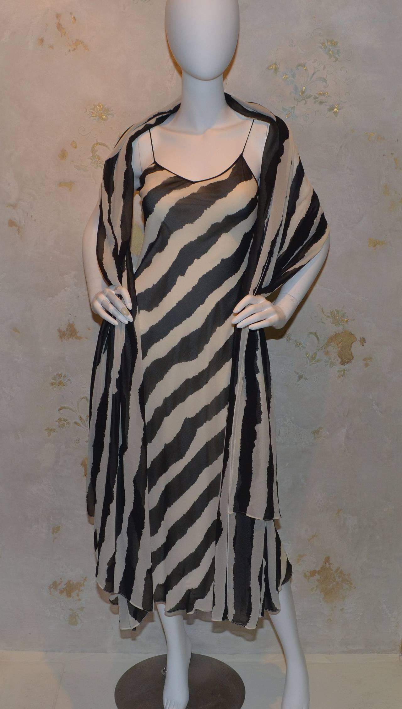 Bruce Oldfield London 1990s dress features a bias cut chiffon fabric throughout and is fully lined. Shawl is large and measures approximately 100 inches long and 52 inches wide.

Measurements:
Bust - 27''
Waist - 26''
Hips - 32''
Length - 49''