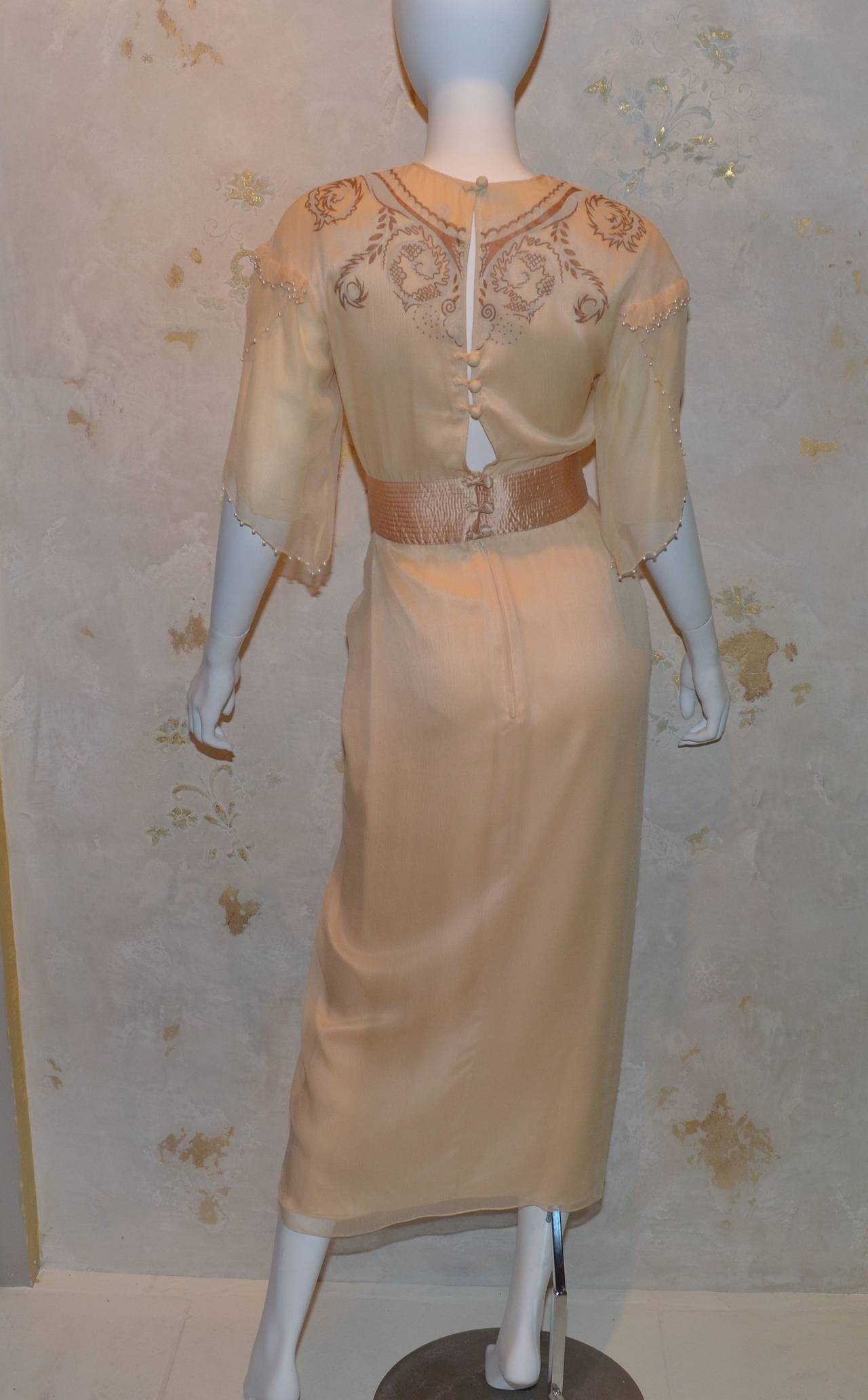 Zandra Rhodes nude chiffon gown, satin waistline, pearl beads, dove gray and copper hand painted design.

Excellent condition.

Zandra Rhodes London Label as well as label with flower that says made in England and Bergdorf Goodman Made in