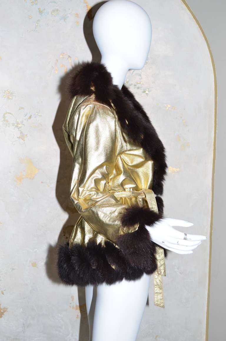 Yves Saint Laurent Vintage 1970's Gold Leather Fur Trimmed Jacket
Quilted silk lining, Gold Leather tie belt, Fox fur / gold lame leather chevron pattern trim at edges.