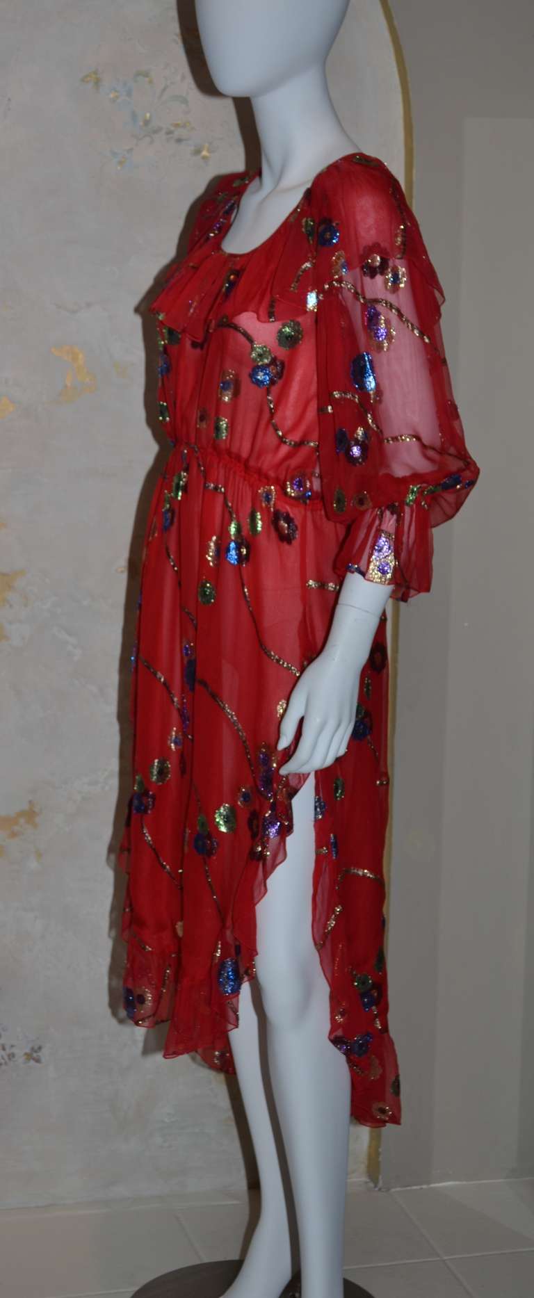 Yves Saint Laurent Vintage YSL Chiffon Dress
Red chiffon with metallic embroidered flowers, elastic waist, peasant neckline, elastic and ruffle at sleeves. Slightly high waisted. French 38 but will fit a 40-42 due to all of the gathering.