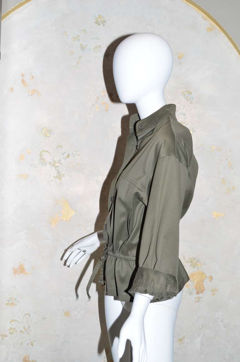 Yves Saint Laurent Rive Gauche Vintage 1970's Safari Jacket
Button front, nehru collar, drawstring waist, elastic at back waist, hidden satin lined pockets in front seams, 3/4 sleeve with cuff and button.