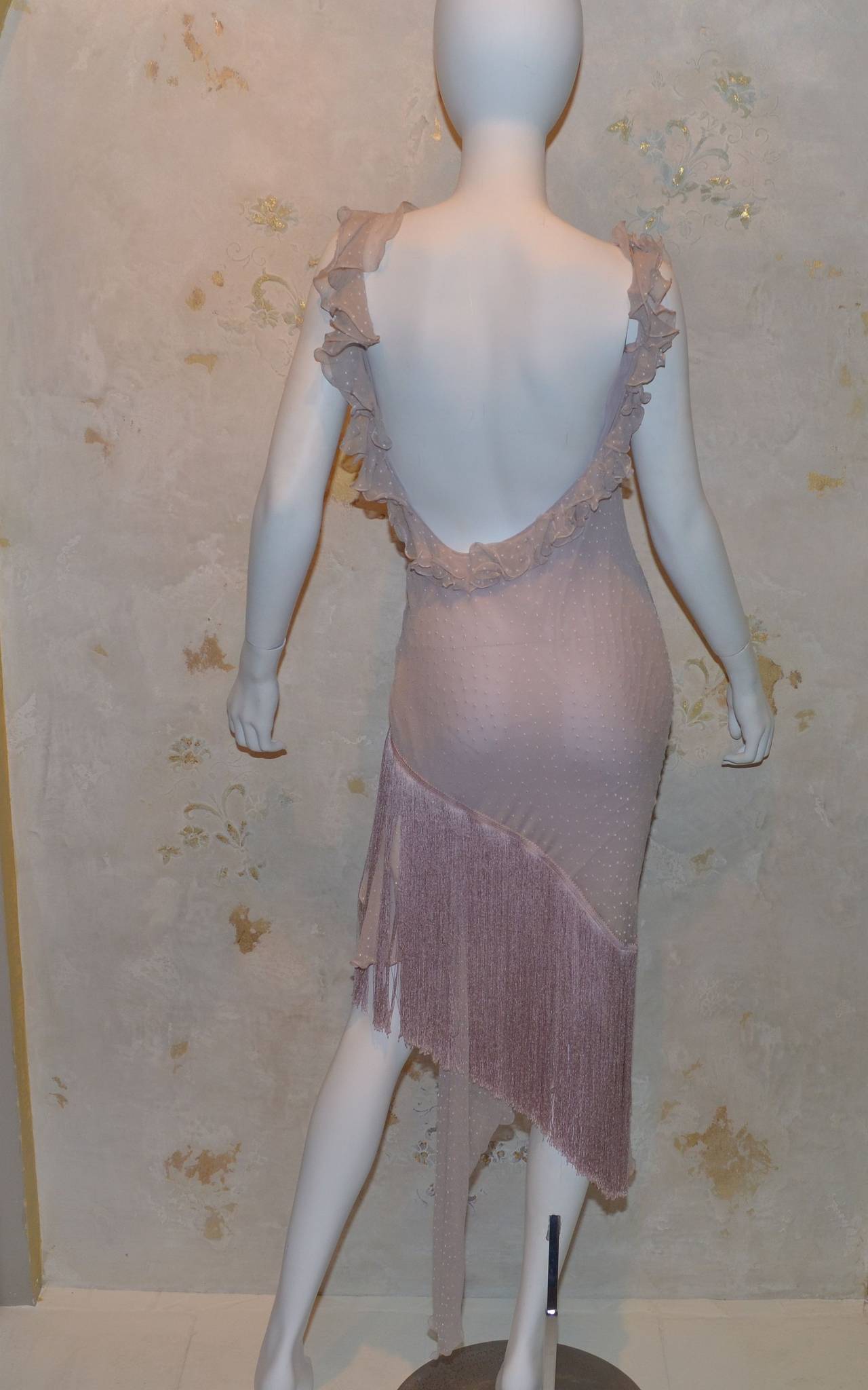John Galliano for Christian Dior bias cut asymmetrical pastel purple/pink dotted swiss silk dress with ruffled detail along the front, swiss dot fabric, assymetric hem with a long fringe and subtle lace trim over one thigh. Dress is fully lined and