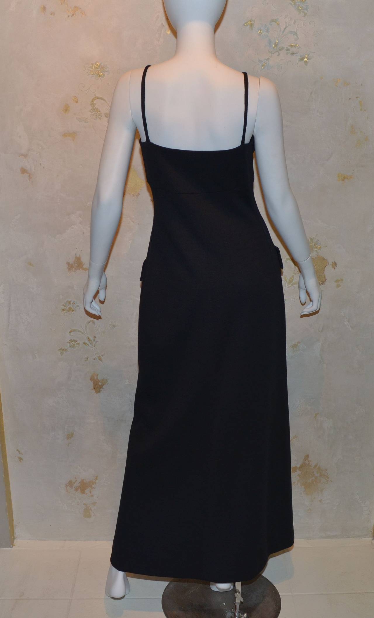 Geoffrey Beene Boutique 1970's double knit dress with exaggerated patch pockets. Buttons down front with large black buttons to the mid thigh. Open slit where buttons end. Dress is fully lined, expert tailoring, elegant in its simplicity. Marked a