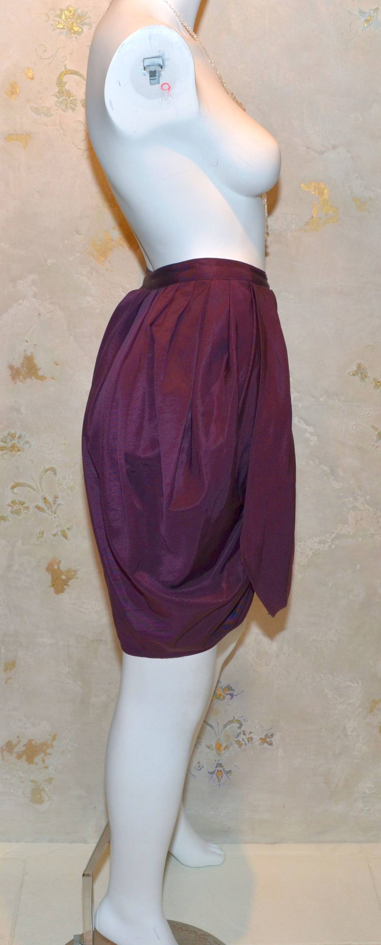 Vintage 1980s Gianni Versace Maroon Purple Wool Silk Blend Skirt with culotte shorts AKA skort. Side button closure and a zipper fastening at the front center, pleated detail along the front and back. Small hole on the front layer as pictured. Made