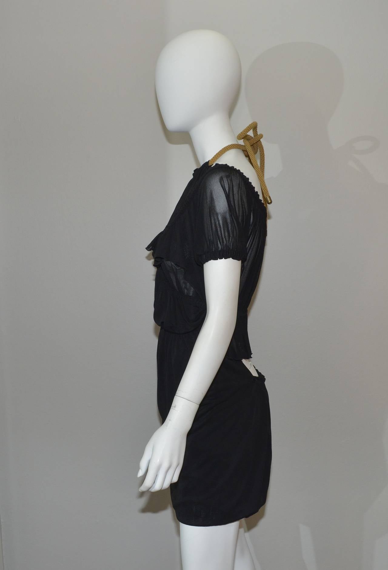 Yves Saint Laurent Dress. Uniquely layered rayon jersey dress has a halter neck with a thick rope closure, partially open back, and ruffled trims. Dress is one long piece of fabric in the front and the halter portion of the dress folds under the