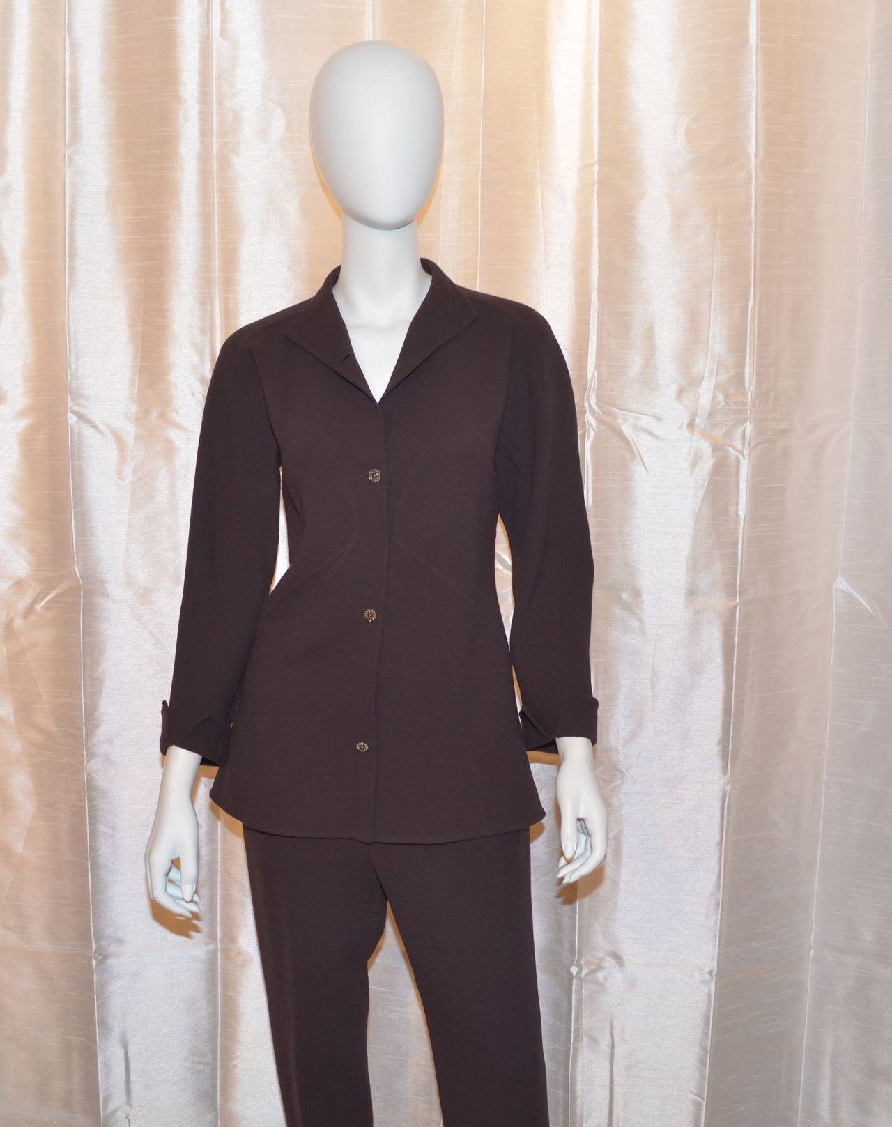 Ralph Rucci suit jacket is a double faced wool with no lining and has four button closures at the front, two holes at the back center for an optional belt that is not included. Welted design lines. Very modern. Pants have a side zipper and