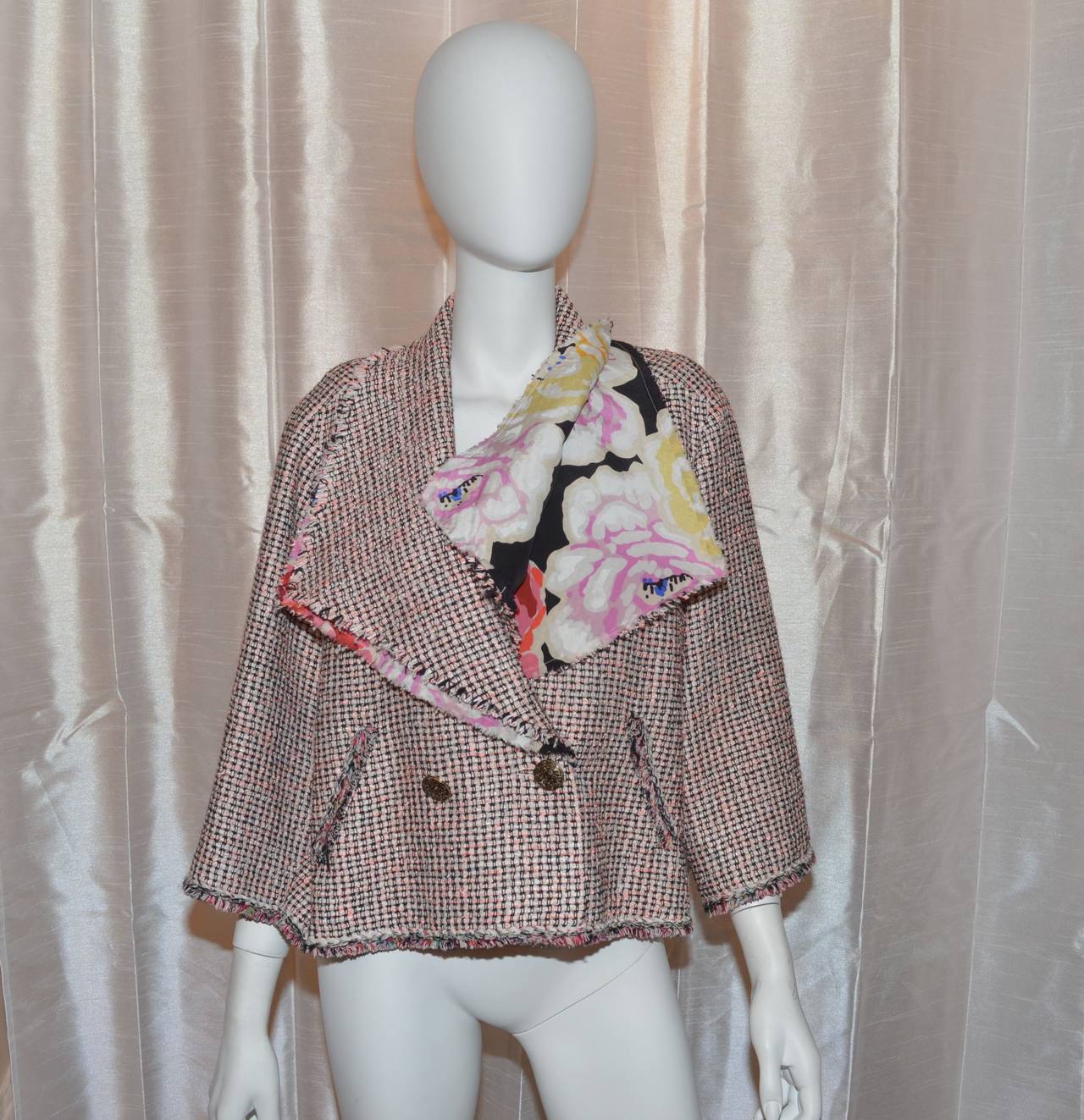 Chanel jacket has two gold-tone front button closures, diagonal pockets at the waist, fringed trimming throughout, beautiful silk floral lining and trim, and a dramatic collar. Made in France. 36% nylon, 29% silk, 15% cotton, 7% wool, 6%