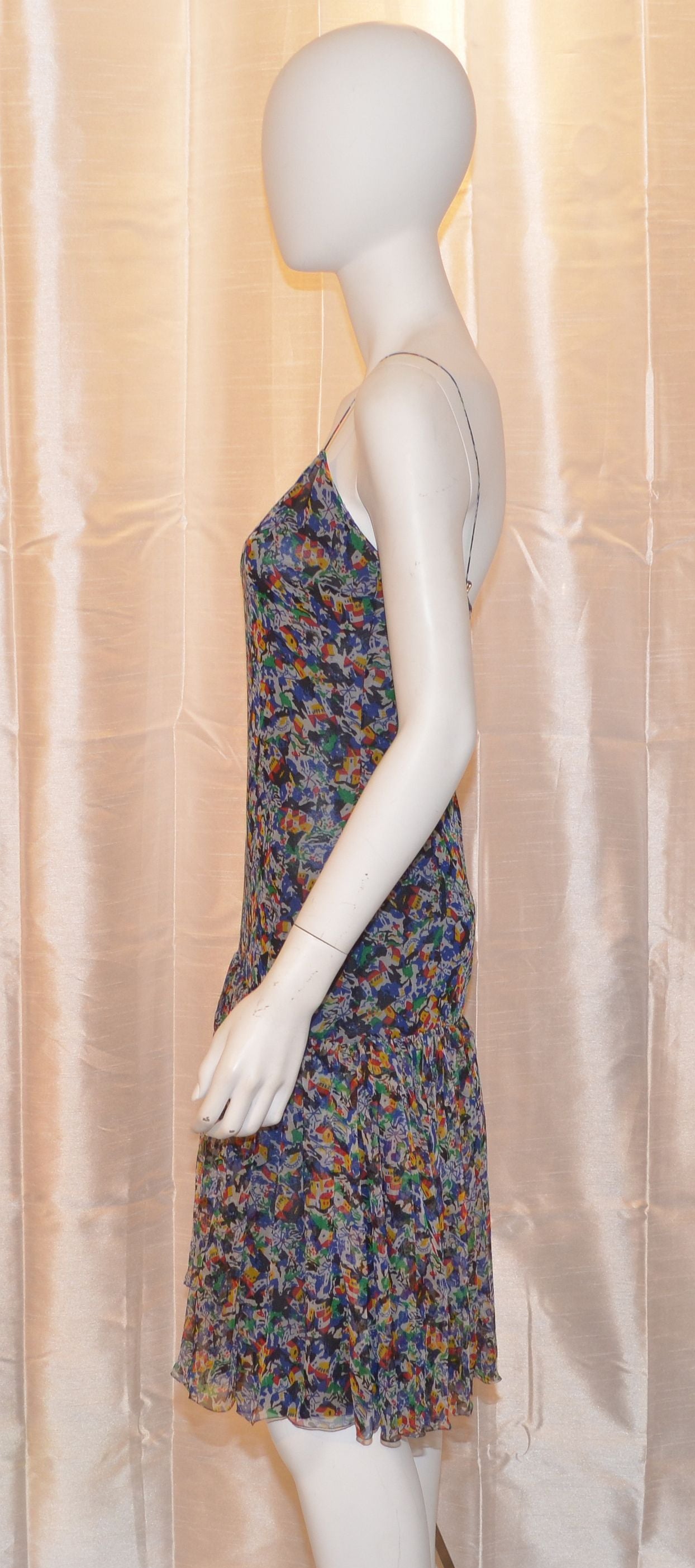 Chanel dress features a unique print throughout with a drop-waist. There is a back zipper and hook-and-eye closure, marked a size 38, and is made in France. 

Measurements:
Bust - 30''
Waist - 28''
Hips - 33''
Length - 40.5''