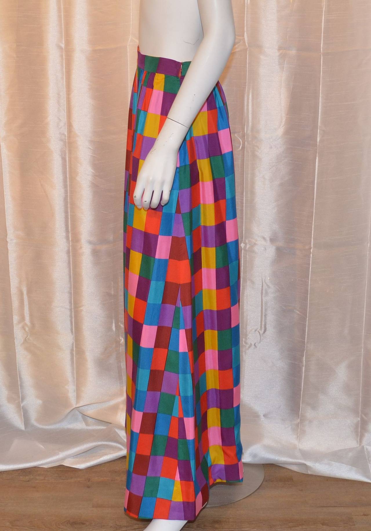 Vintage Valentino skirt features an op art multicolor print with a side zipper and hook-and-eye closure. Side seams are matched. Expert construction and excellent condition. Made in Italy of 100% silk. Labeled a size 12 (modern 6) with measurements