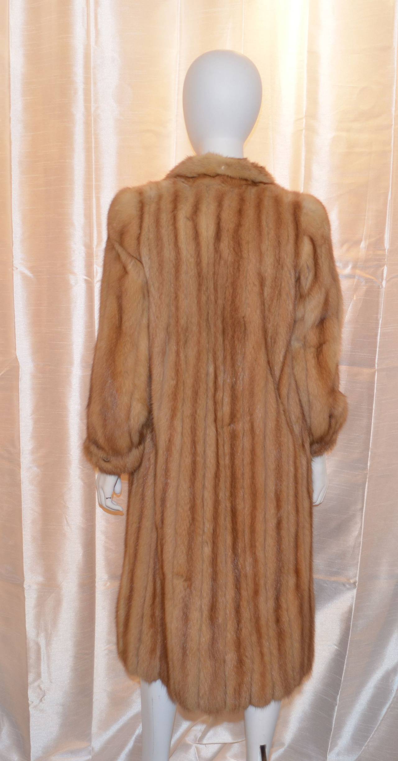 Canadian Sable fur coat is light weight and has been previously stored by a furrier,  hook-and-eye closures along the front center, and a button and loop closure at the cuffs. Fully lined. Soft supple fur with no hard spots, repairs or tears to the
