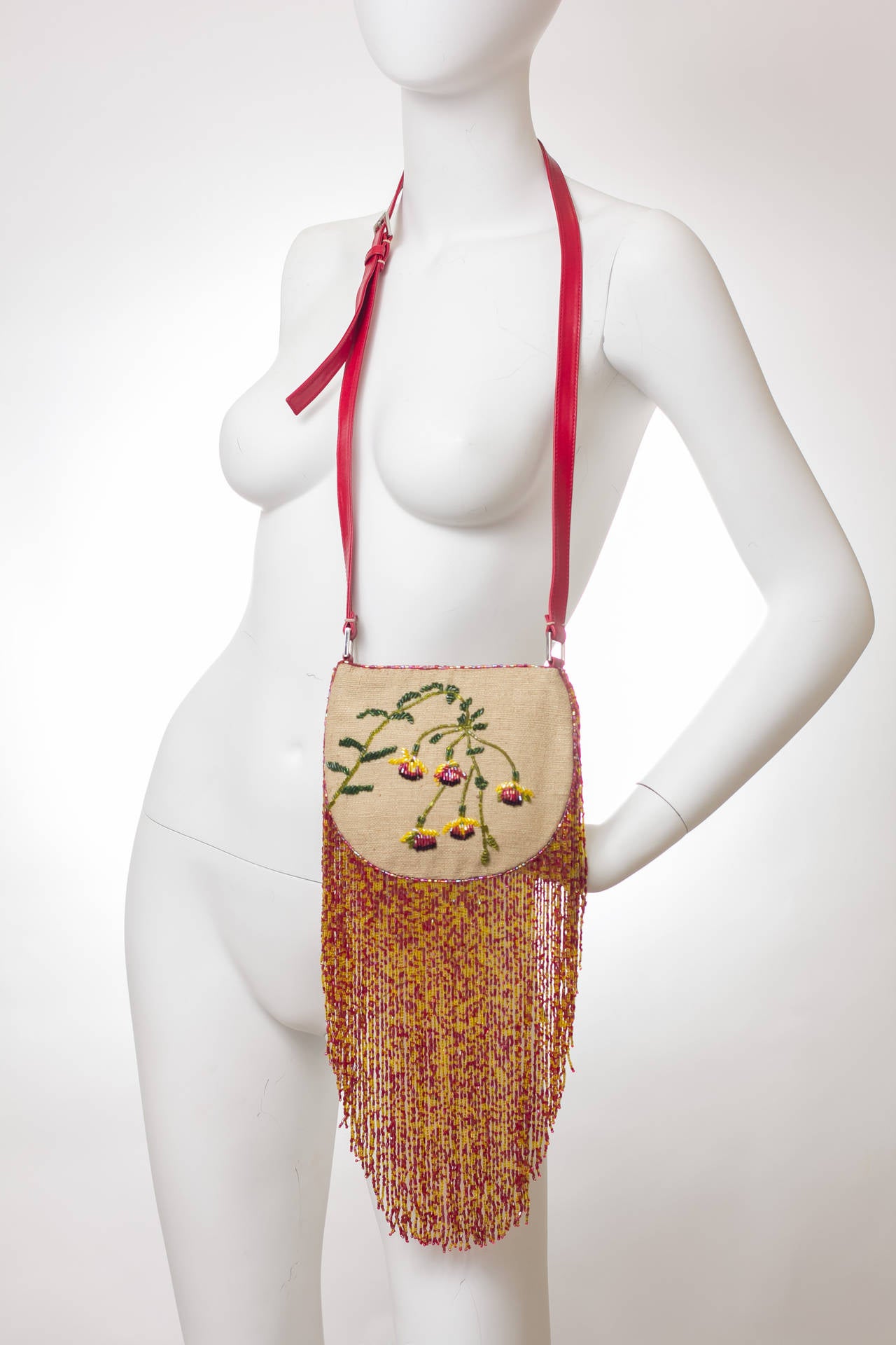 Valentino cross body or shoulder handbag with exquisite beaded and embroidered design and beaded fringe. Lined in silk. Magnetic closure. 

Measurements:
Pouch 6