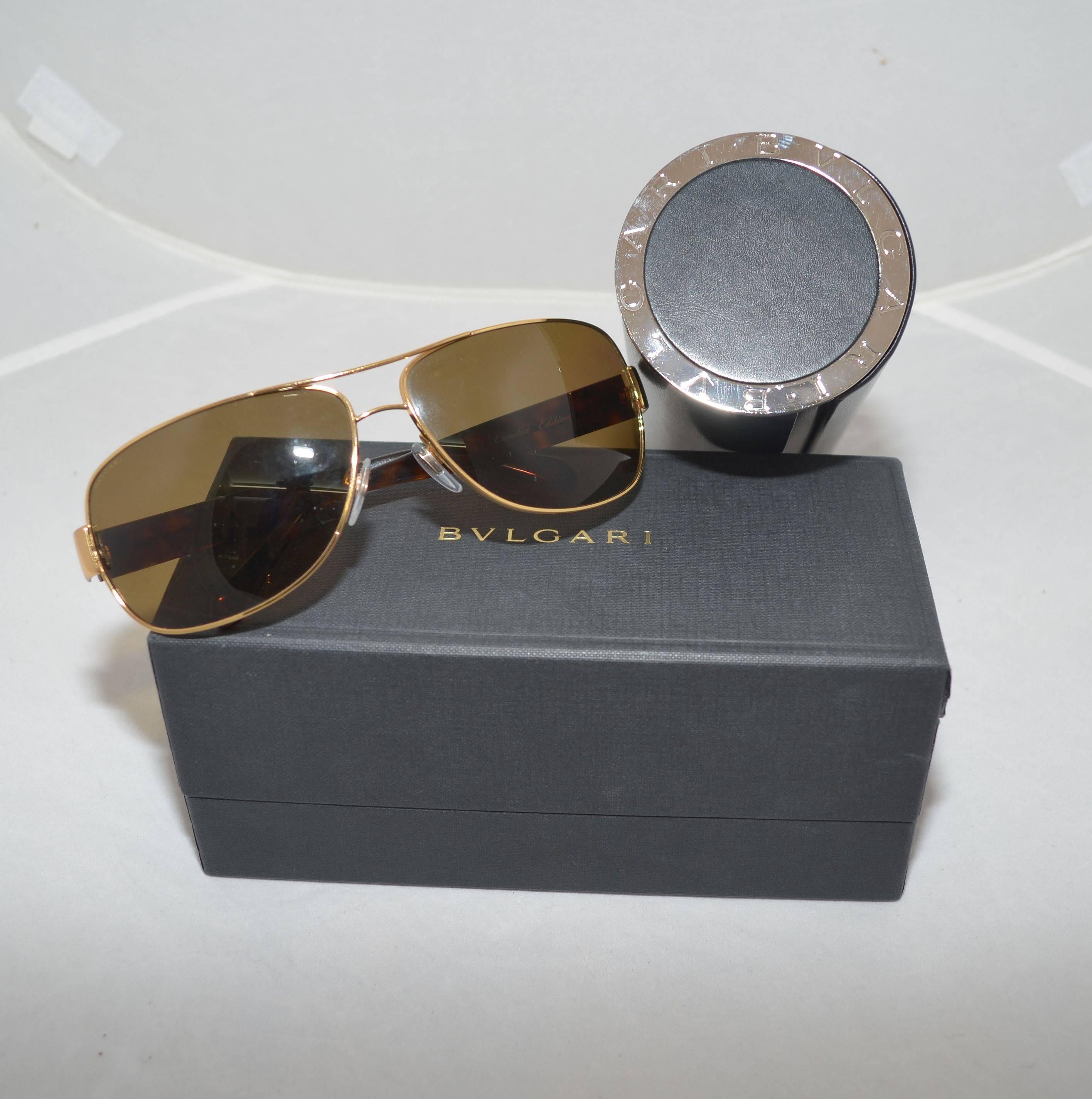 Bvlgari limited edition aviator sunglasses features an 18k gold plated rectangular frame, tortoise brown temples with 'Bvglari' markings, and polarized lenses. Original box and case are included. Made in Italy.