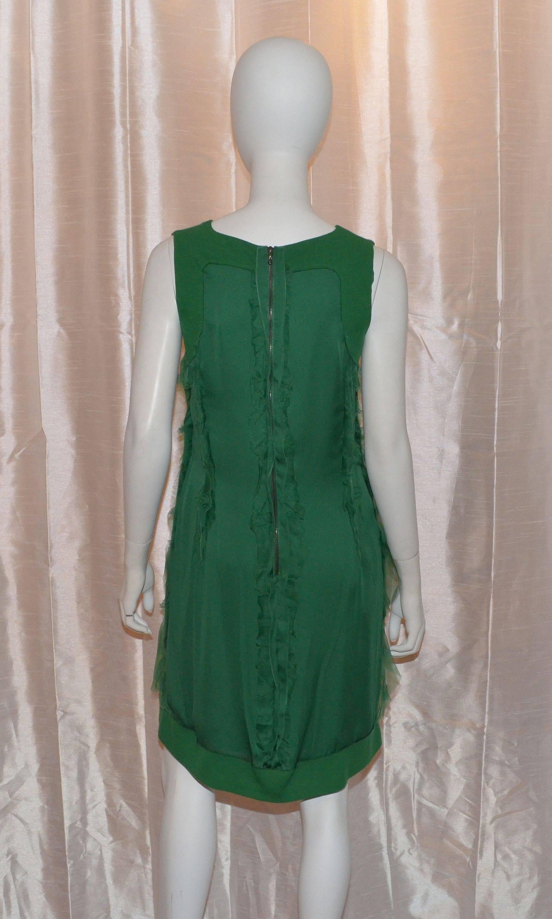 Lanvin dress is made with 100% wool and silk chiffon fabric, ruffled detailing throughout back zipper and snap closures, and fully lined in 100% silk. Made in France, size 40. Original tags still attached. Gorgeous emerald green