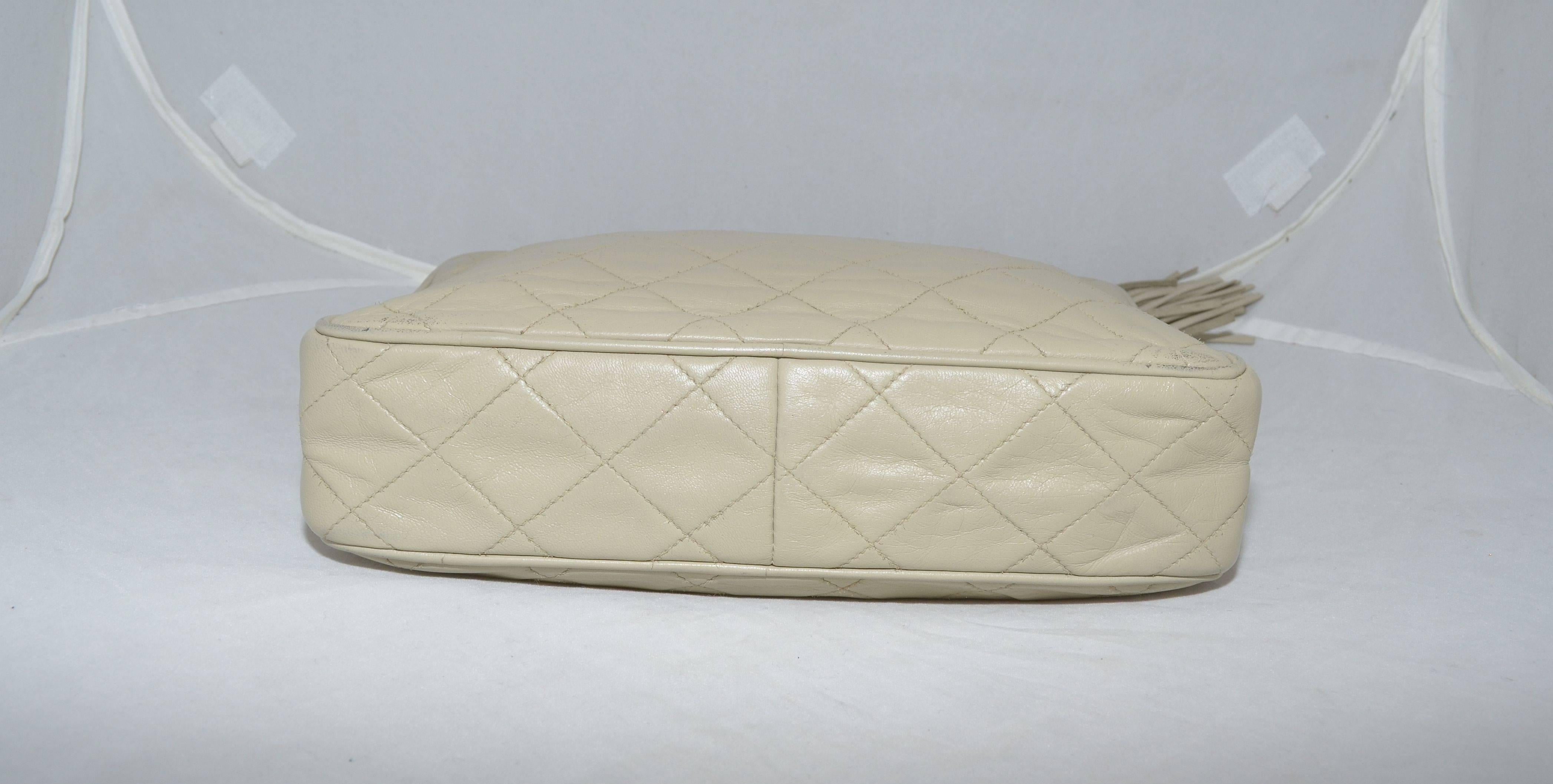 Vintage Chanel bag from 1986-1988. Vintage Leather Camera Bag with Tassel has a soft leather tassel as a zipper closure along the top, quilting to the leather at the front and back, and one slip pocket at the front. Lined in leather with one zipper