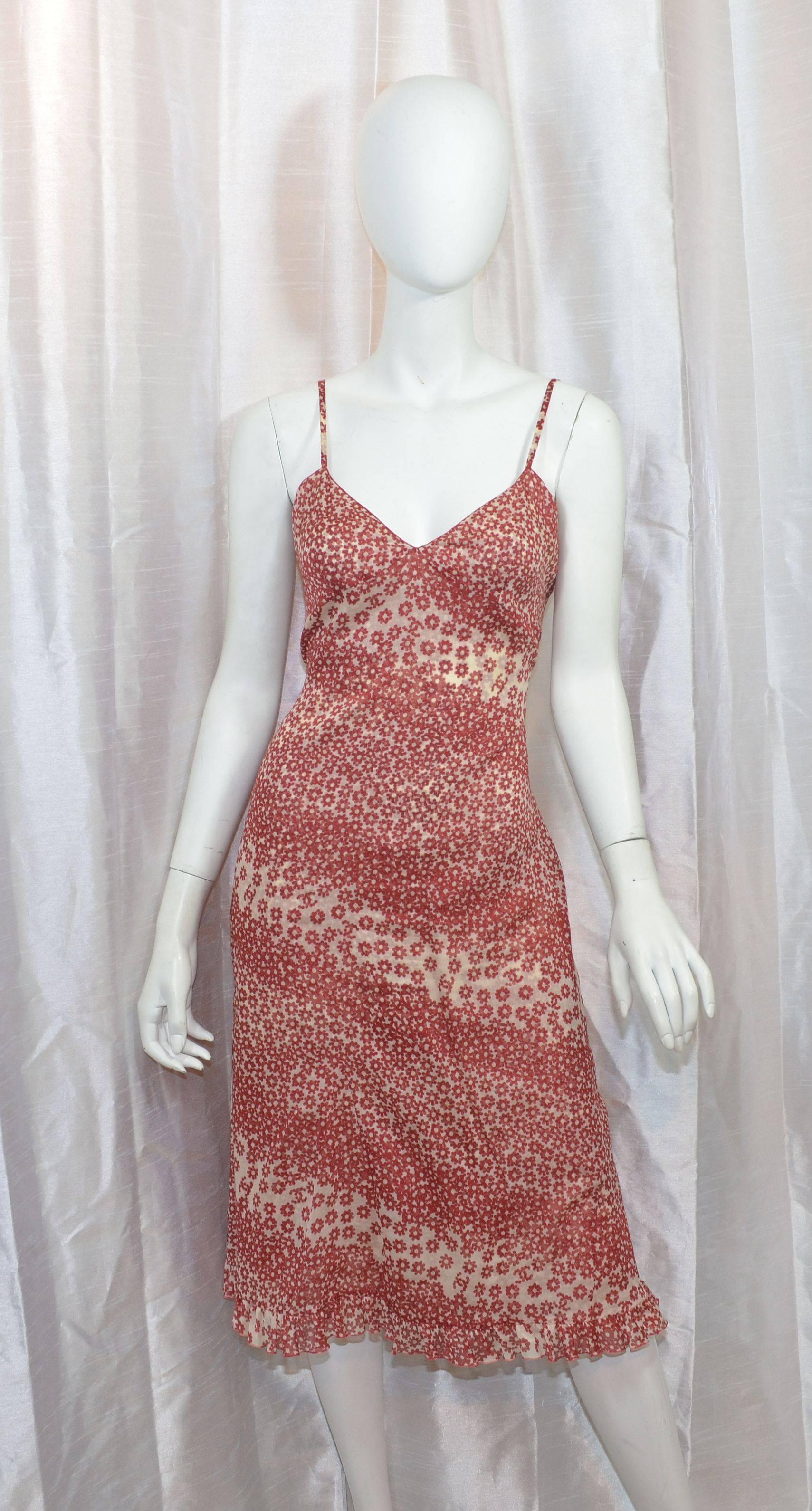 Chanel 2003 Spring collection dress set in a red and beige floral print. Dress set incudes a slip dress and a button-front duster or cover dress. Slip dress has spagetti shoulder straps, a ruffled hem, and a back zipper and hook-and-eye fastening.
