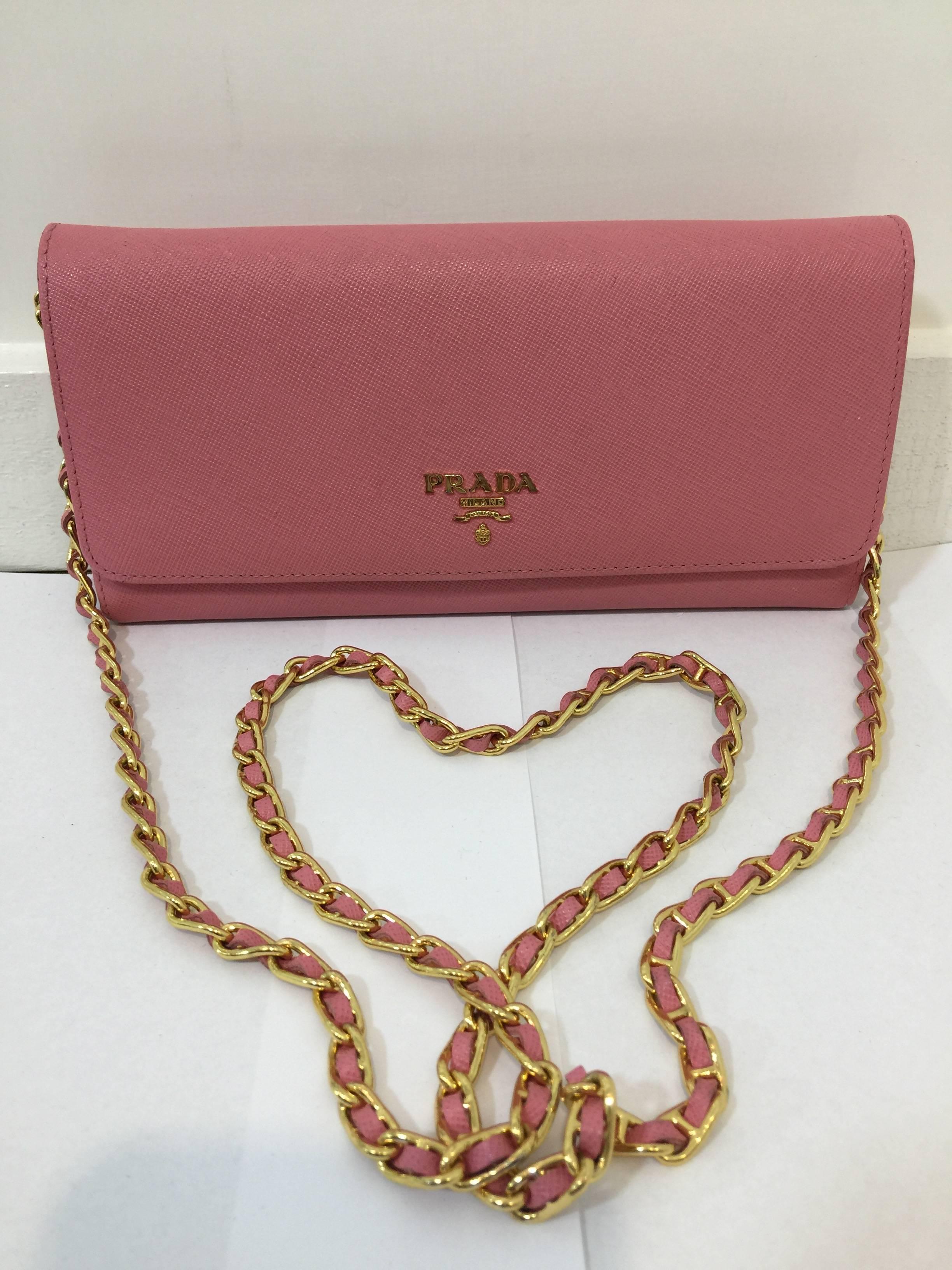 Prada Pink Saffiano Leather Wallet on a Chain 

Classic Wallet on a Chain by Prada features dual snap closure, 8 credit card slots, 5 open pockets and 1 zippered pocket. Overall good condition with light wears throughout, some marks on bottom 2