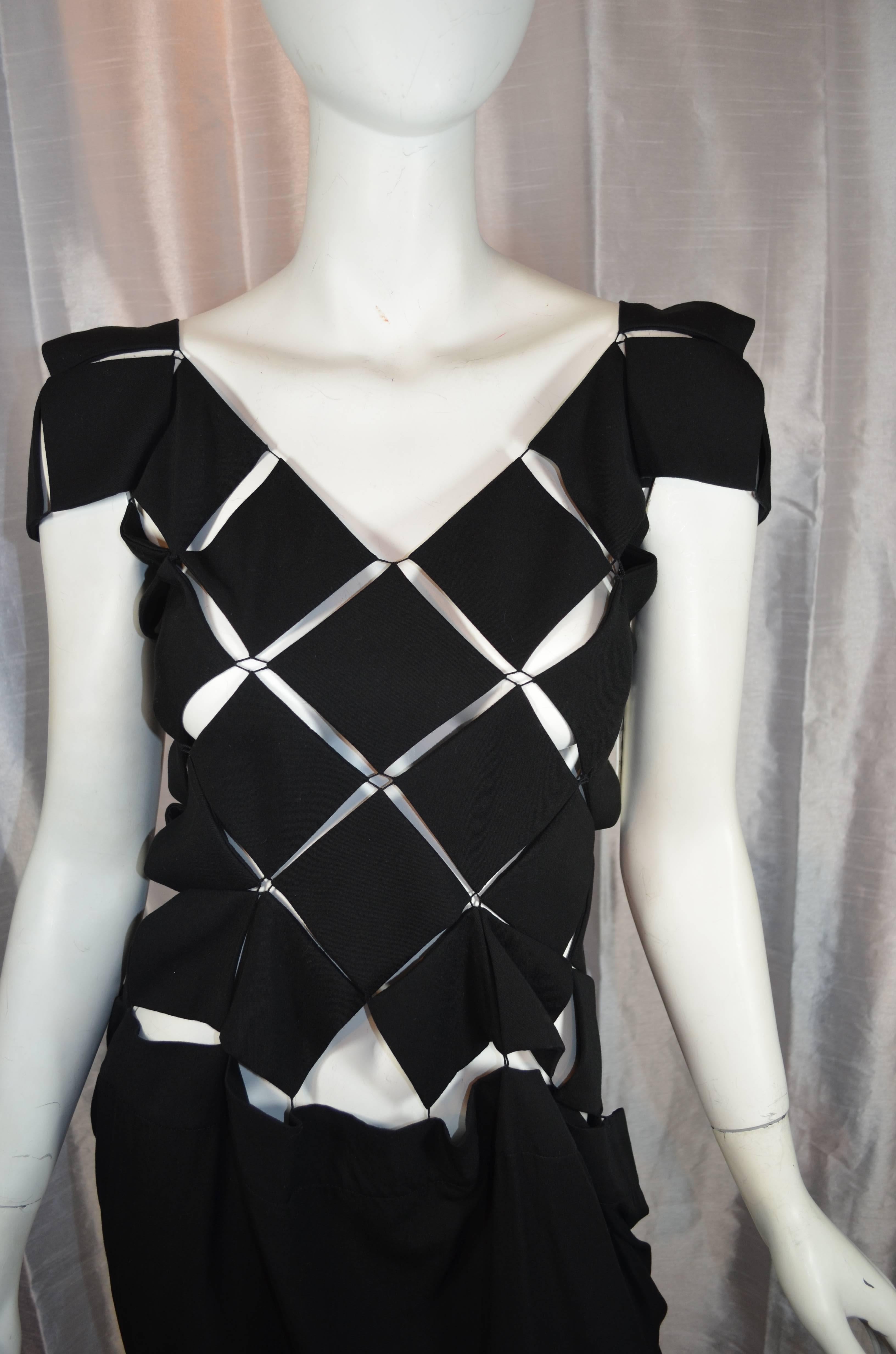 Rare Yohji Yamamoto Dress

Bodice is comprised of diamond panels stitched together at corners. Skirt is unstructured and suspended from corners of diamond panels. Jewelry clasp closures in the back. Excellent condition.

Size 1. 100%