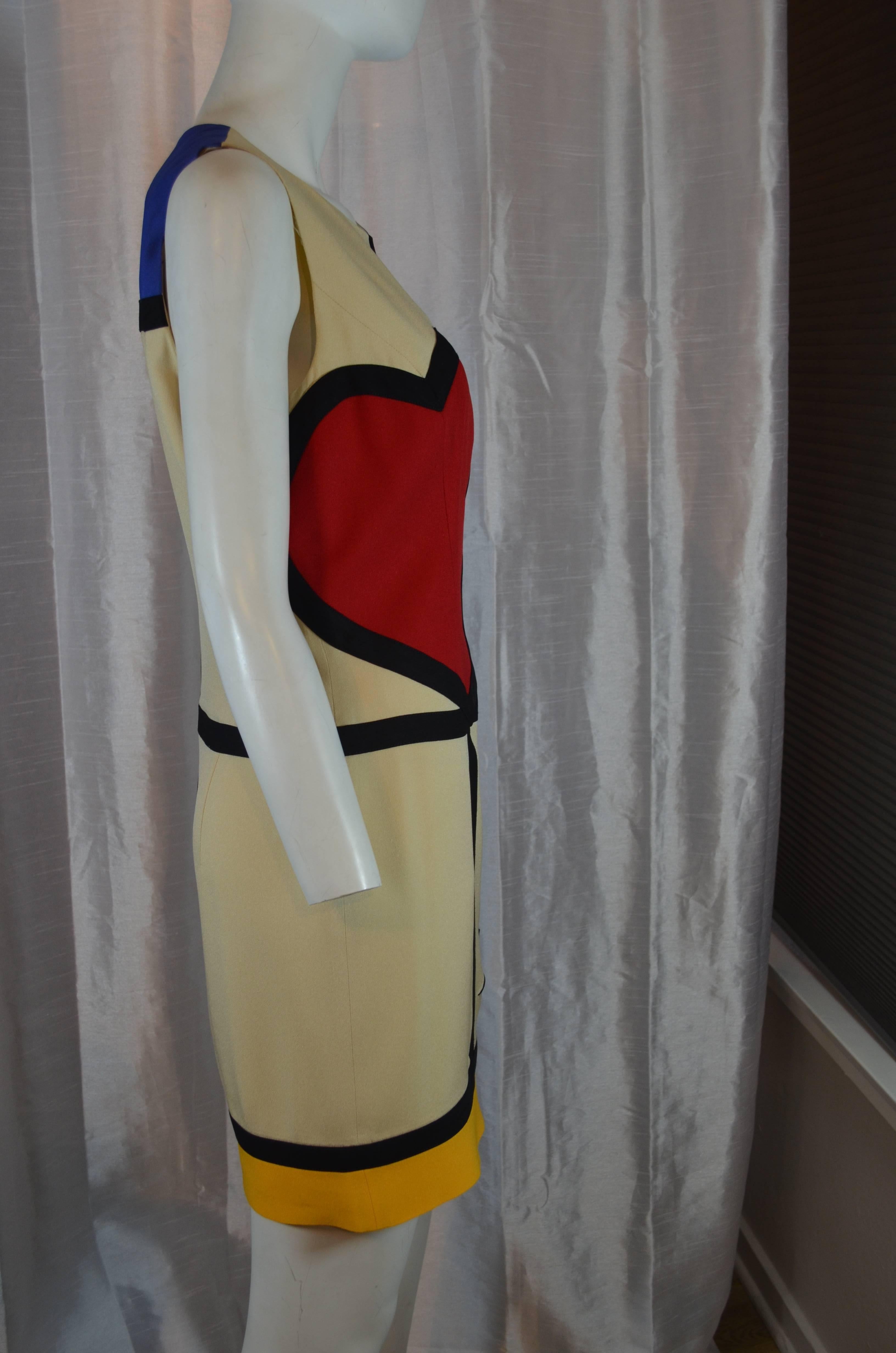 Early Moschino Mondrian inspired dress in black cream and primary colors. Sleeveless, back zipper, round neckline, fully lined. 'Art is Love' is written at the front, large heart appliqué, black trim. Labeled: Cheap and Chic by Moschino. Fabric