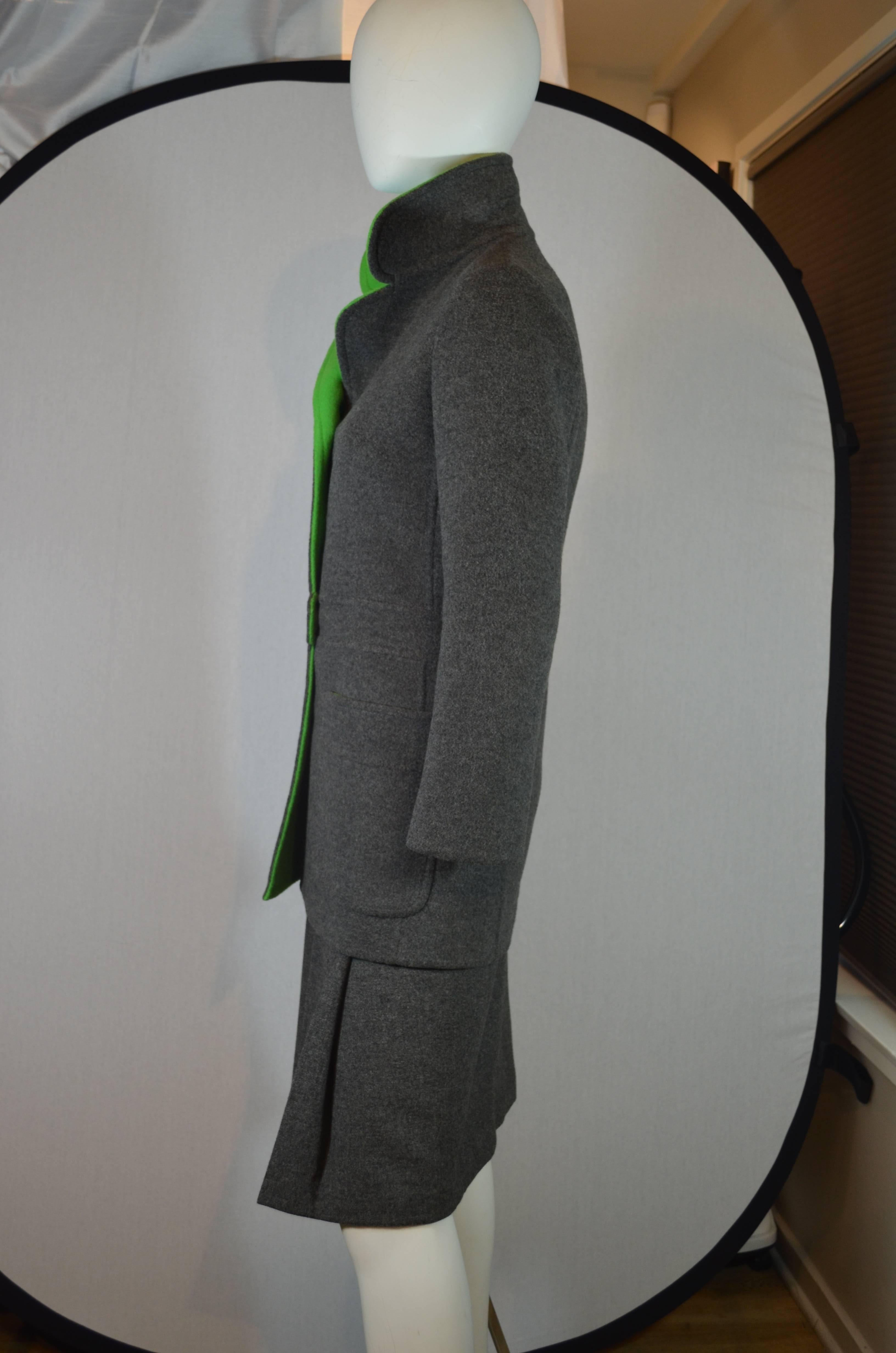 Christian Dior for I.Magnin  grey wool skirt with matching grey suit jacket with apple green trim collar.  Grace Kelly was photographed wearing this suit in 1972. The jacket has a button up front, welted belt detail at waist, patch pockets and hip
