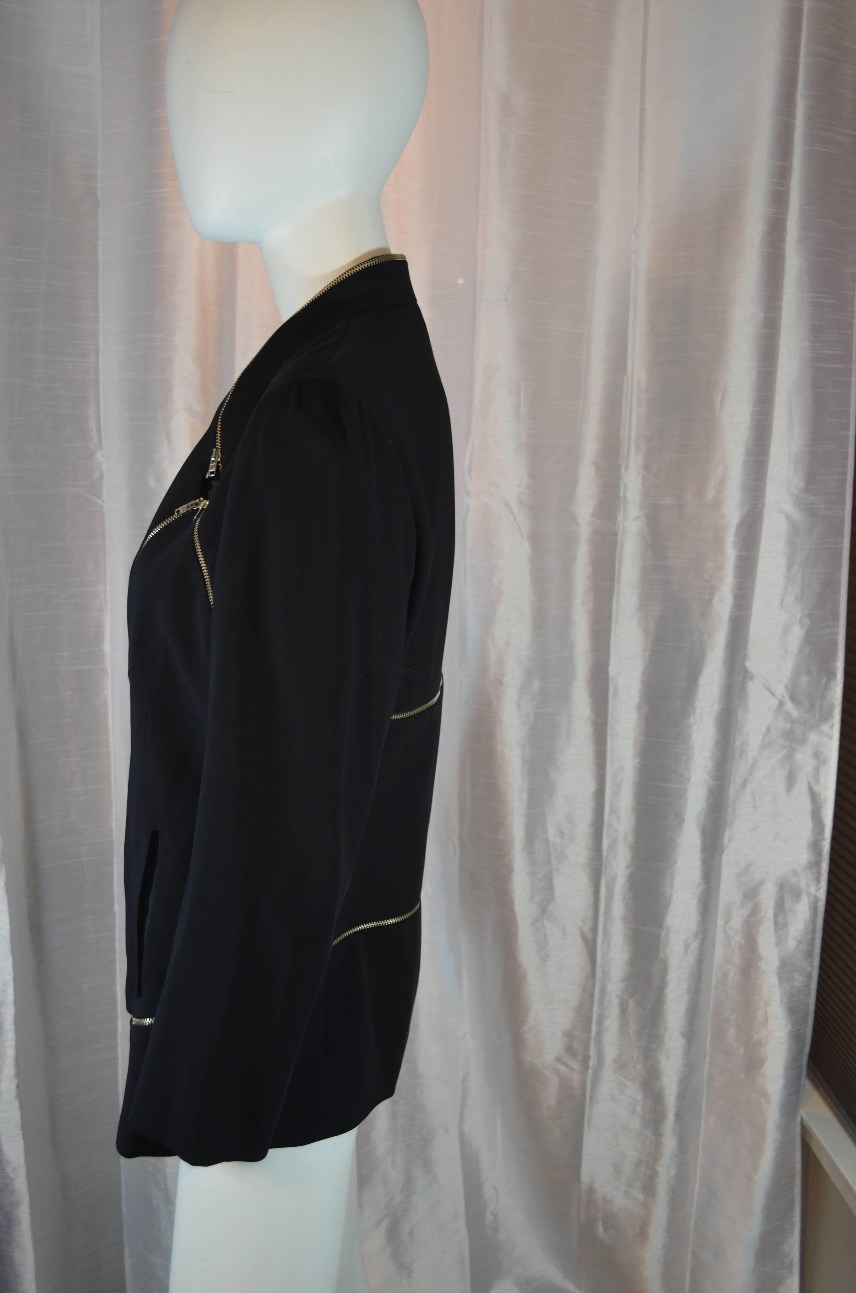 Hussein Chalayan, designer of the table dress and many other convertible pieces of clothing, convertible 2 way jacket features a zip out panel which allows jacket to be zipped up in a shorter way or worn longer in all one fabric and finally worn