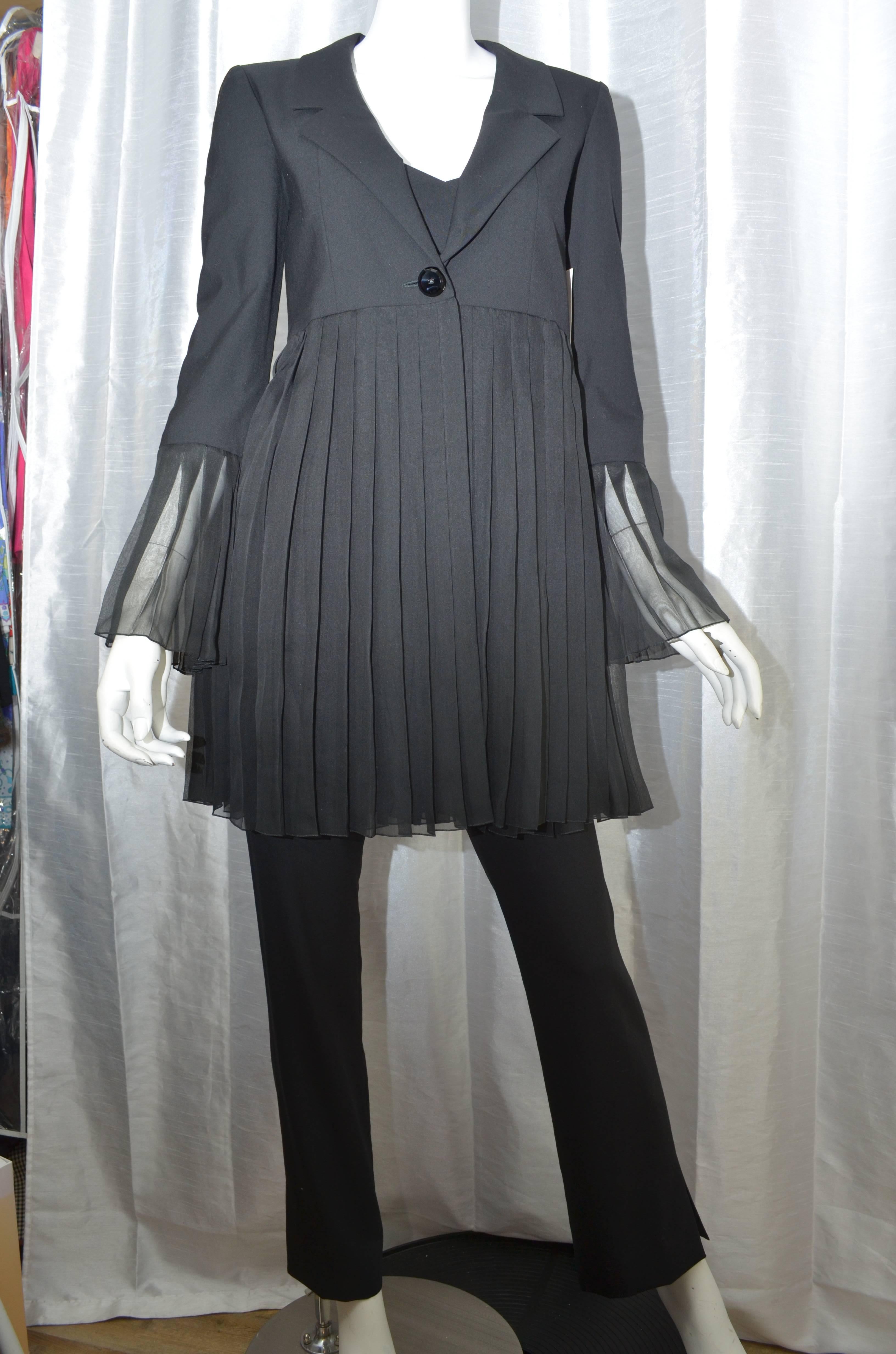 Chanel Black 3 Piece Pant Suit, Spring 2001
This set includes black pants, a partially sheer baby doll style top with spaghetti straps and a jacket with a pleated sheer bottom half. Pants are lightweight with a zipper on the side and small slits on