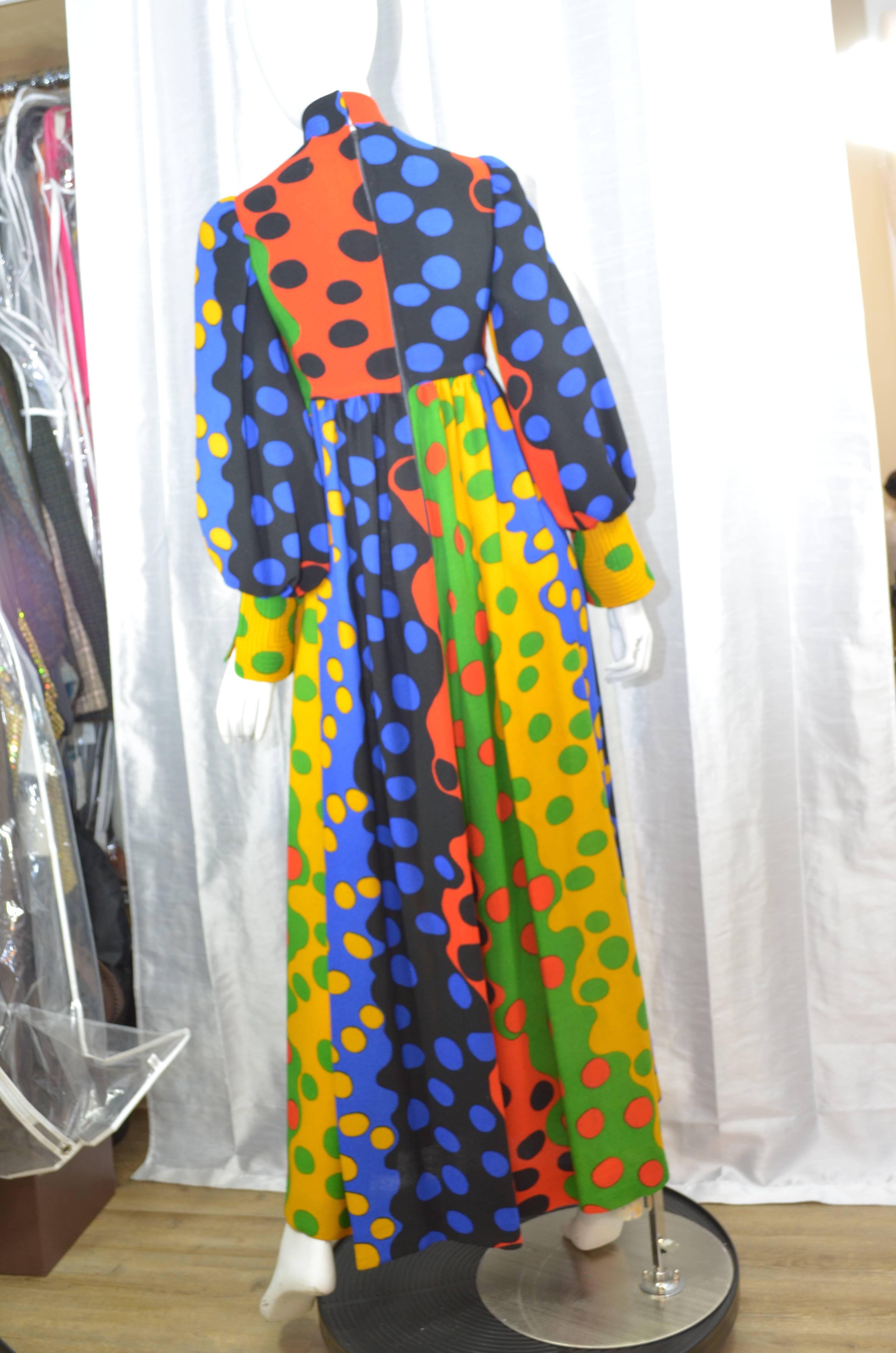 1970s London designer Jean Muir printed moss-crepe evening gown, circa 1970, featuring fabric printed with bold undulating colour blocks and outsized polka dots. Maxi dress features full sleeves with fitted cuffs and multiple rows of stitching at