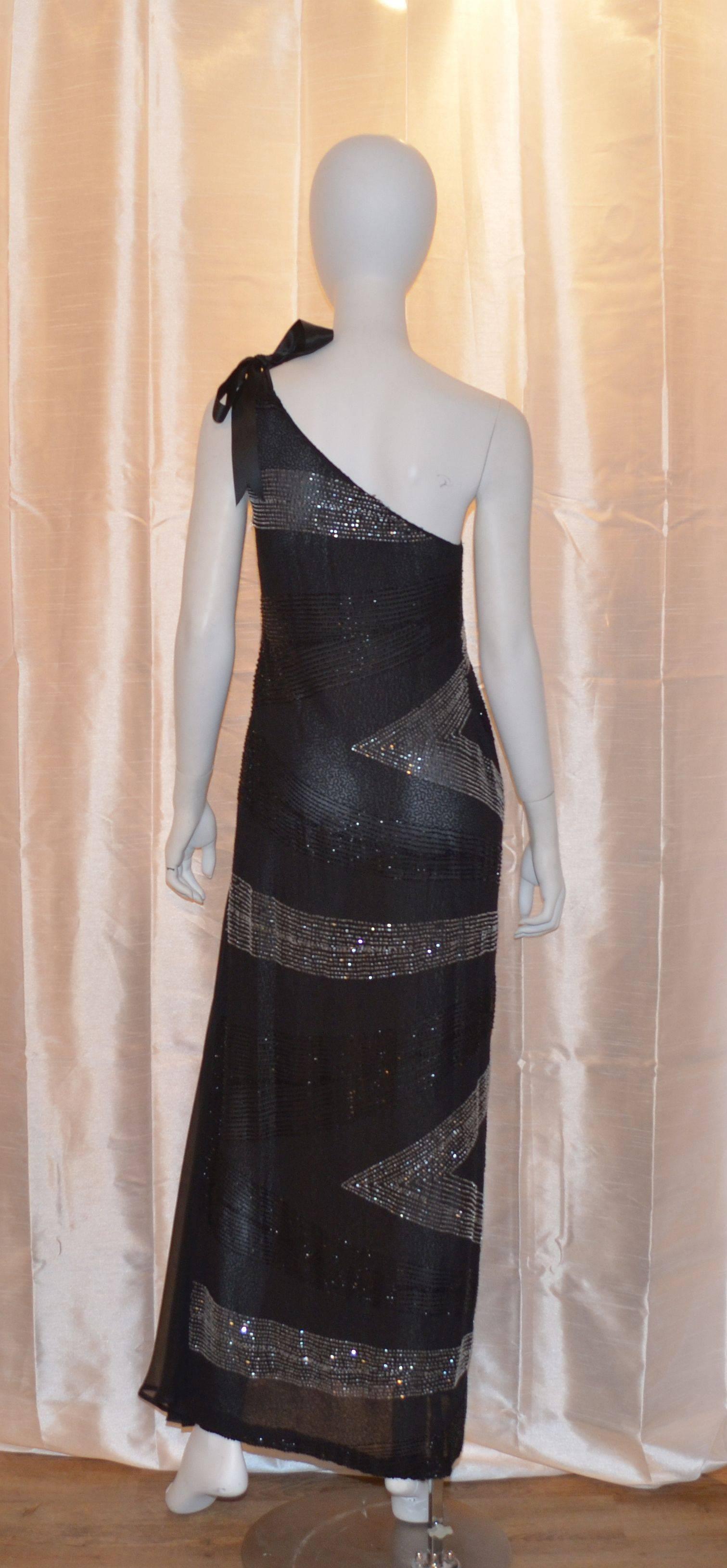 Alfred Fiandaca mid 1990's bias cut gown features black and silver beading throughout, elegant one-shoulder style with a ribbon tie, side zipper and hook-and-eye closure, and a train on the left side of the hem.  Very light weight. Photo ad of gown