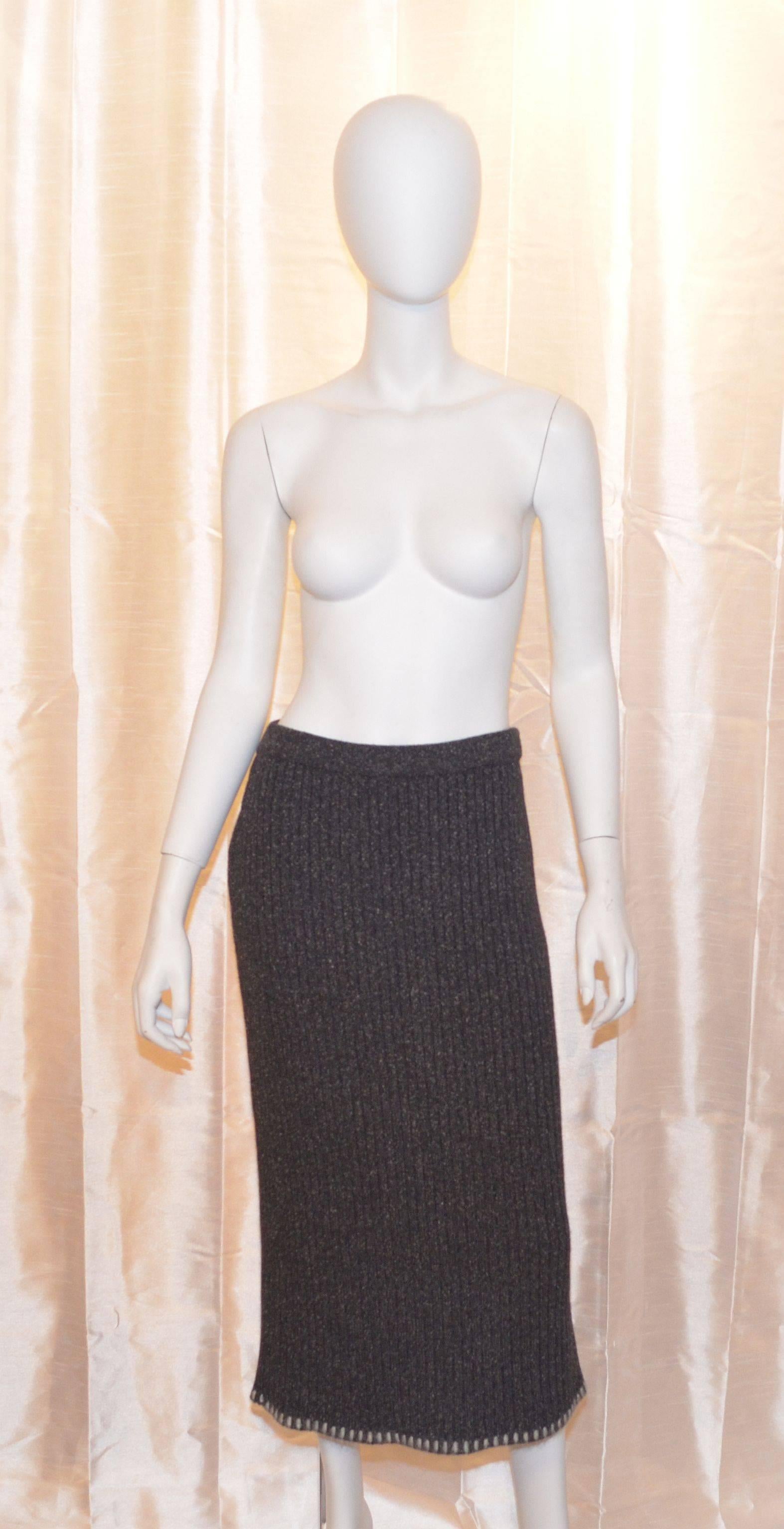 Christian Dior mohair, angora, silk blend knit set is made with 35% nylon, 25% mohair, 20% wool, 15% silk, and 5% angora. Turtleneck and skirt are stretchy and ribbed. Skirt has an elasticized waistband. Size L, made in Italy.

Measurements: