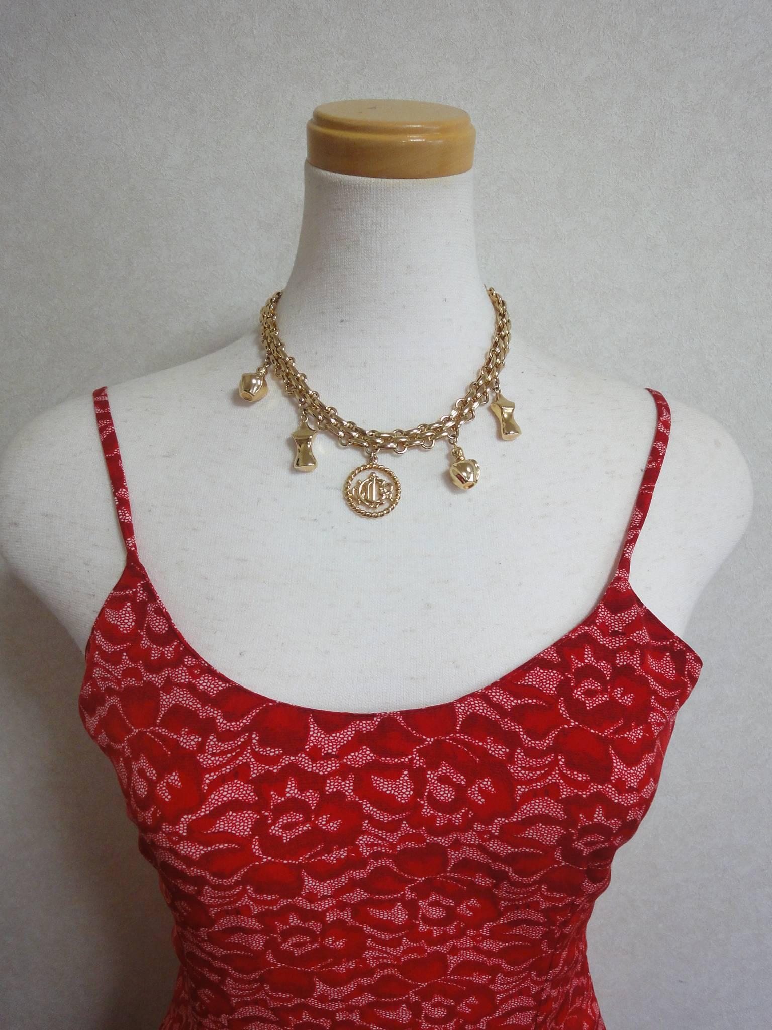 Vintage Christian Dior statement necklace with CD, perfume, torso motifs. Perfect Dior vintage jewelry gift

This is a vintage gold-tone luxury and gorgeous statement necklace!
Featuring dangling motifs of "Dior", torso, and perfume shape