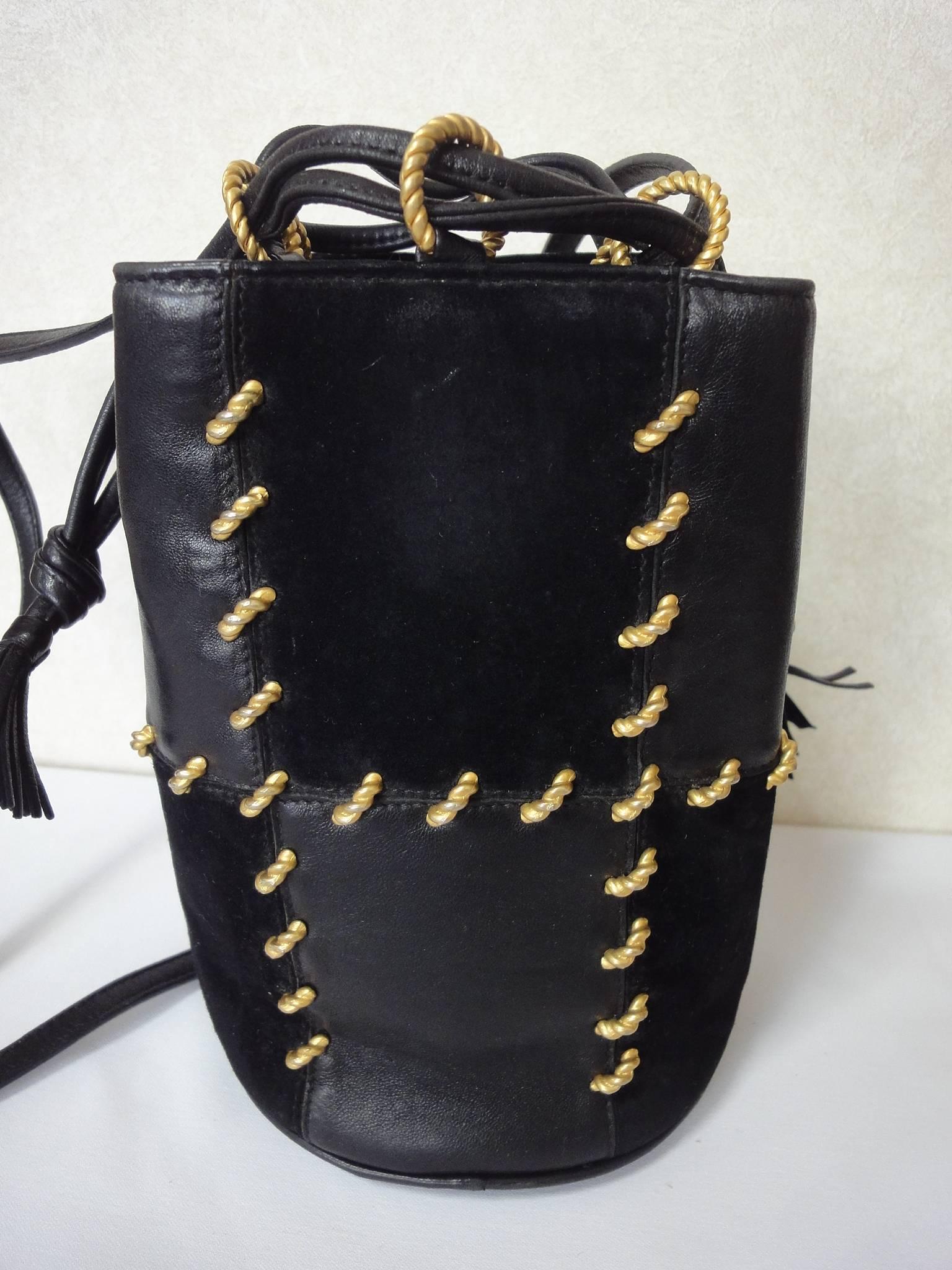 Vintage Salvatore Ferragamo black smooth and suede leather combination mini shoulder purse. Hobo bucket style bag. Great for daily use.

Introducing another masterpiece from Salvatore Ferragamo back in the early 90s.
Black smooth and suede