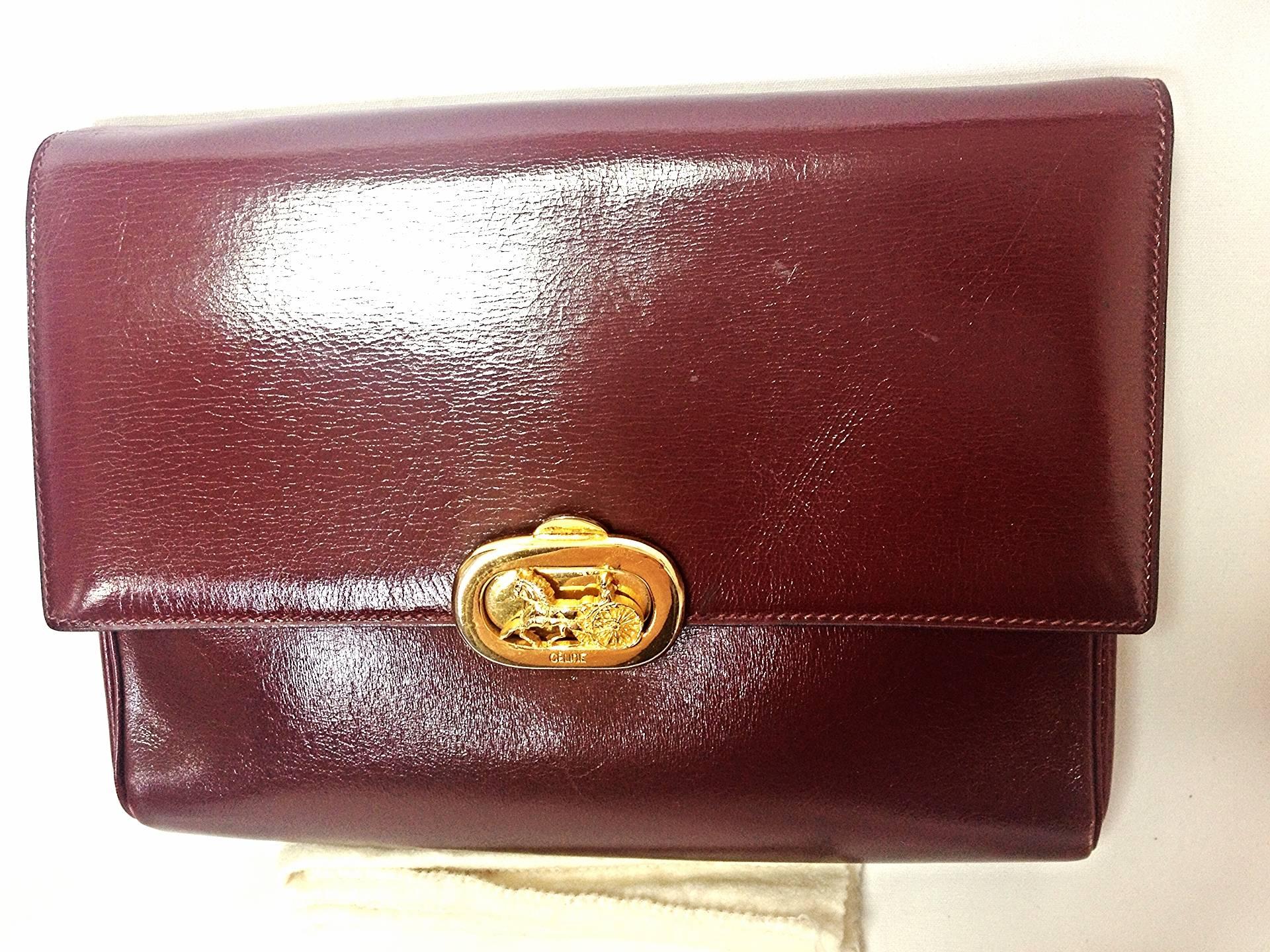 Brown intage CELINE genuine wine brown leather clutch bag with golden carriage logo.