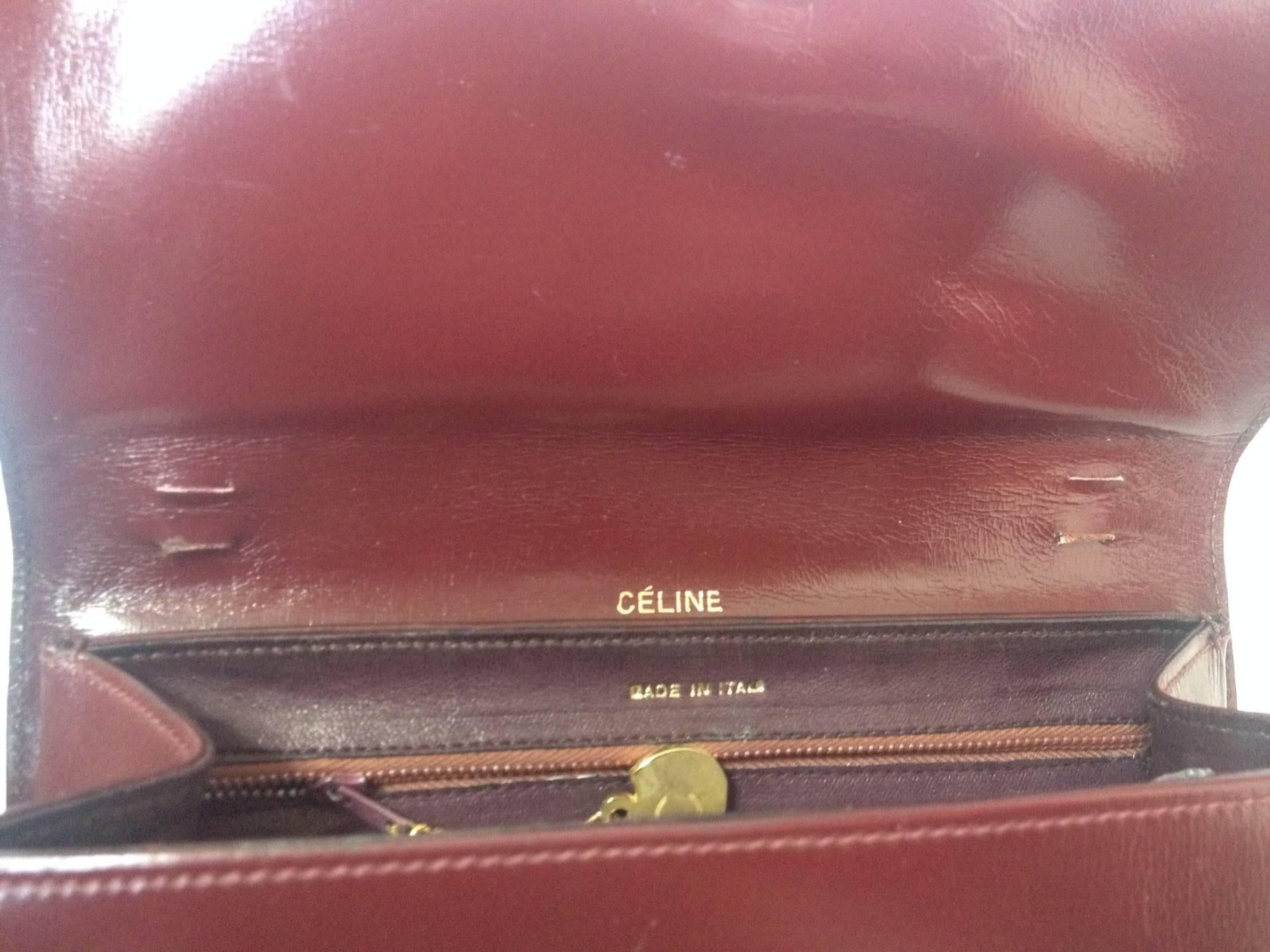 Women's or Men's intage CELINE genuine wine brown leather clutch bag with golden carriage logo.