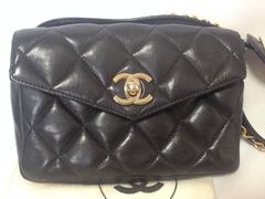 Vintage CHANEL black leather waist purse, fanny bag with golden chain belt.
