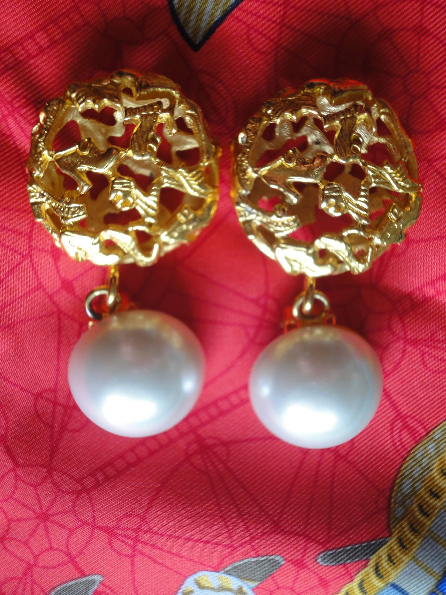 Vintage Salvatore Ferragamo white faux pearl earrings with golden shoe design featured charm. Ferragamo dangling earrings.

Introducing a vintage Salvatore Ferragamo faux pearl earrings with golden motif.
One of a kind earrings from Ferragamo!