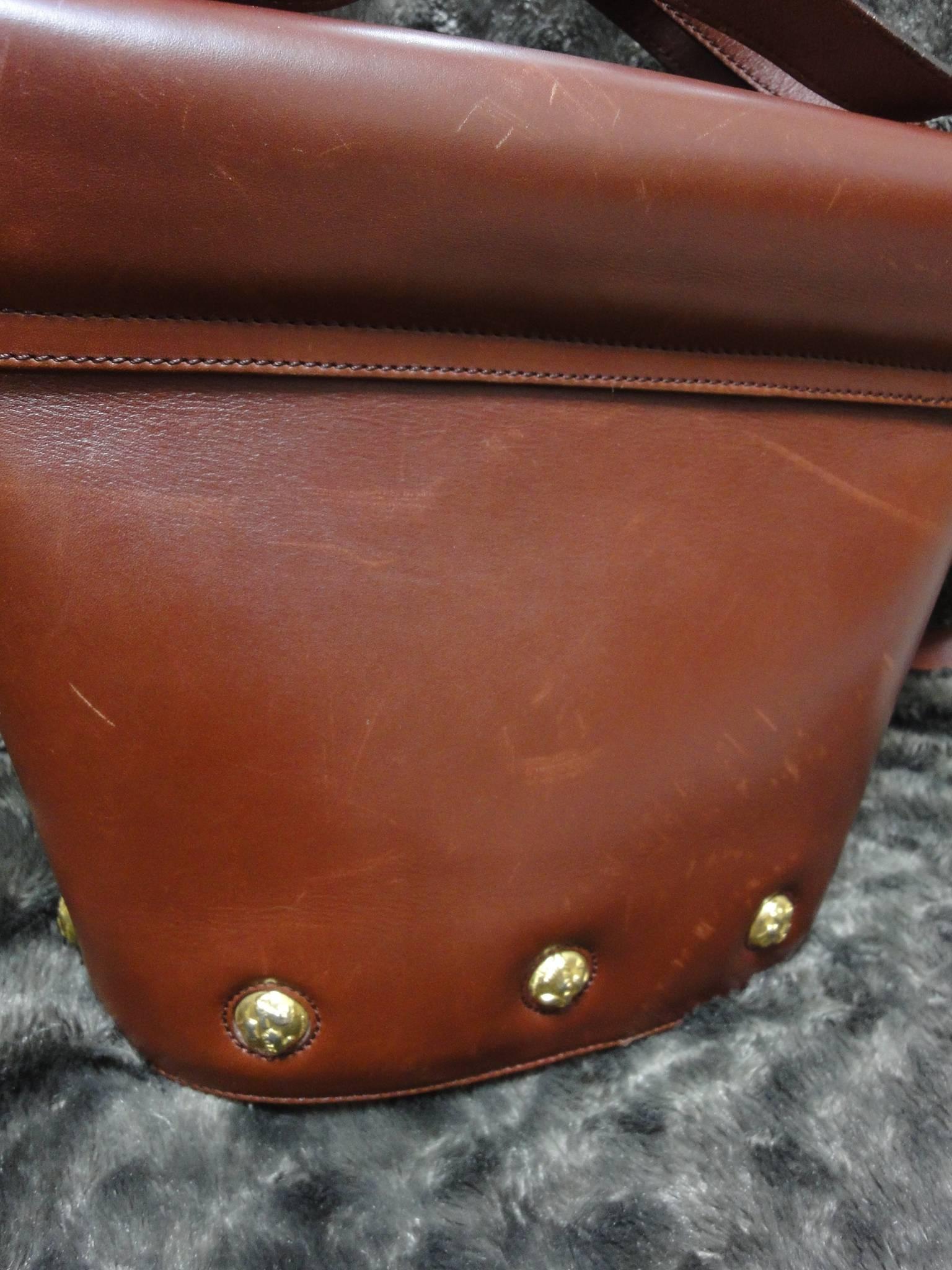 Brown Vintage Salvatore Ferragamo brown leather trapezoidal shape purse with motifs.