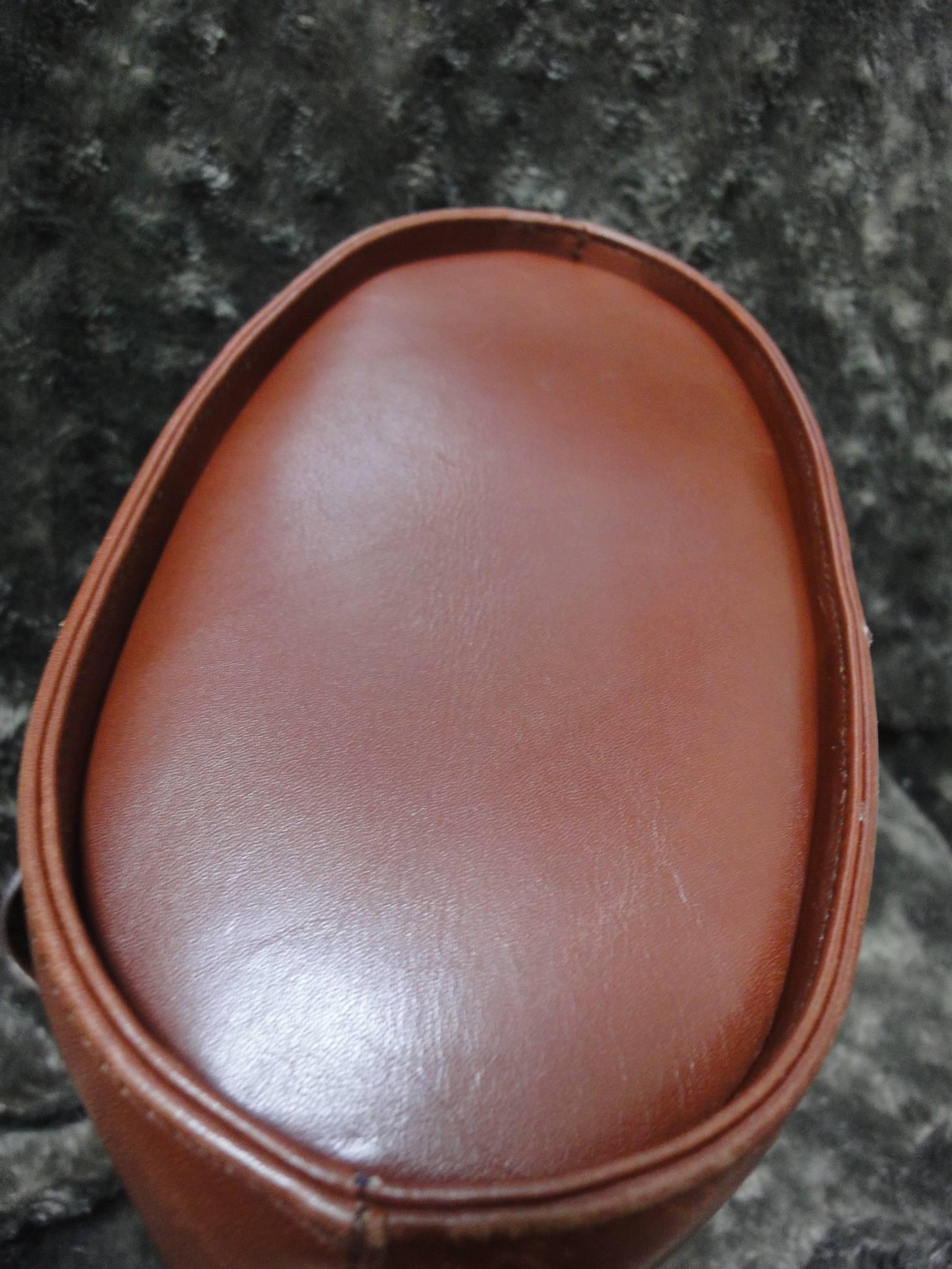 Vintage Salvatore Ferragamo brown leather trapezoidal shape purse with motifs. 1