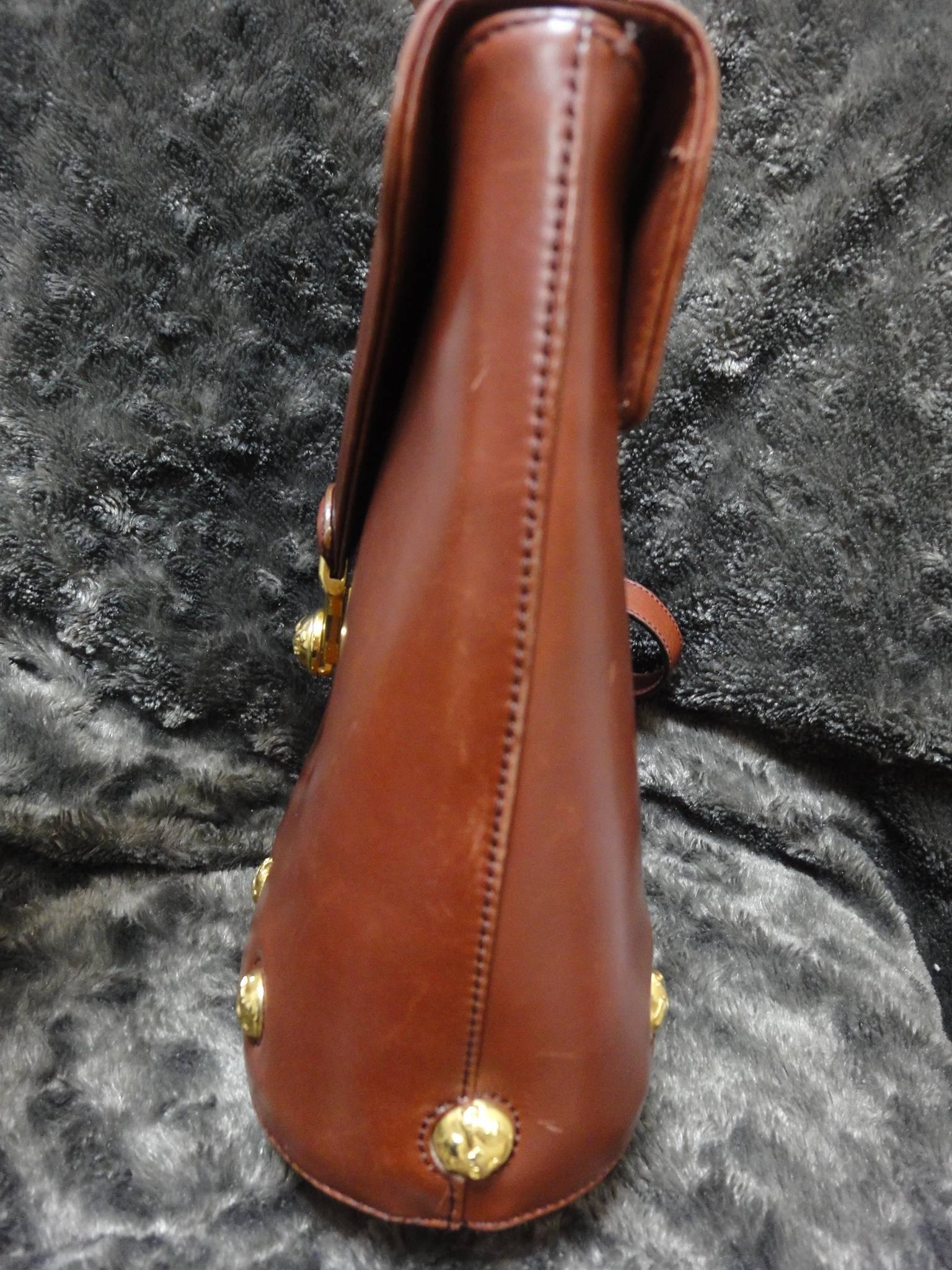 Vintage Salvatore Ferragamo brown leather trapezoidal shape purse with motifs. 2