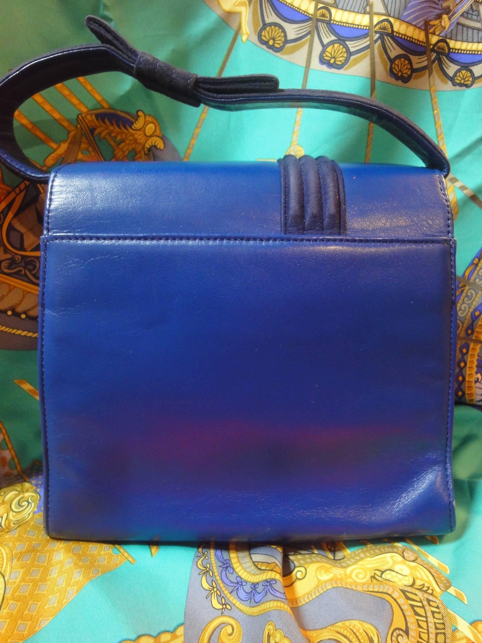 Vintage Gianni Versace blue smooth and suede leather handbag purse with a bow. Gaga and chic style.

If you are a vintage Gianni Versace lover or looking for a rare piece, then this is the must-have piece for sure!
Vintage handbag in blue leather