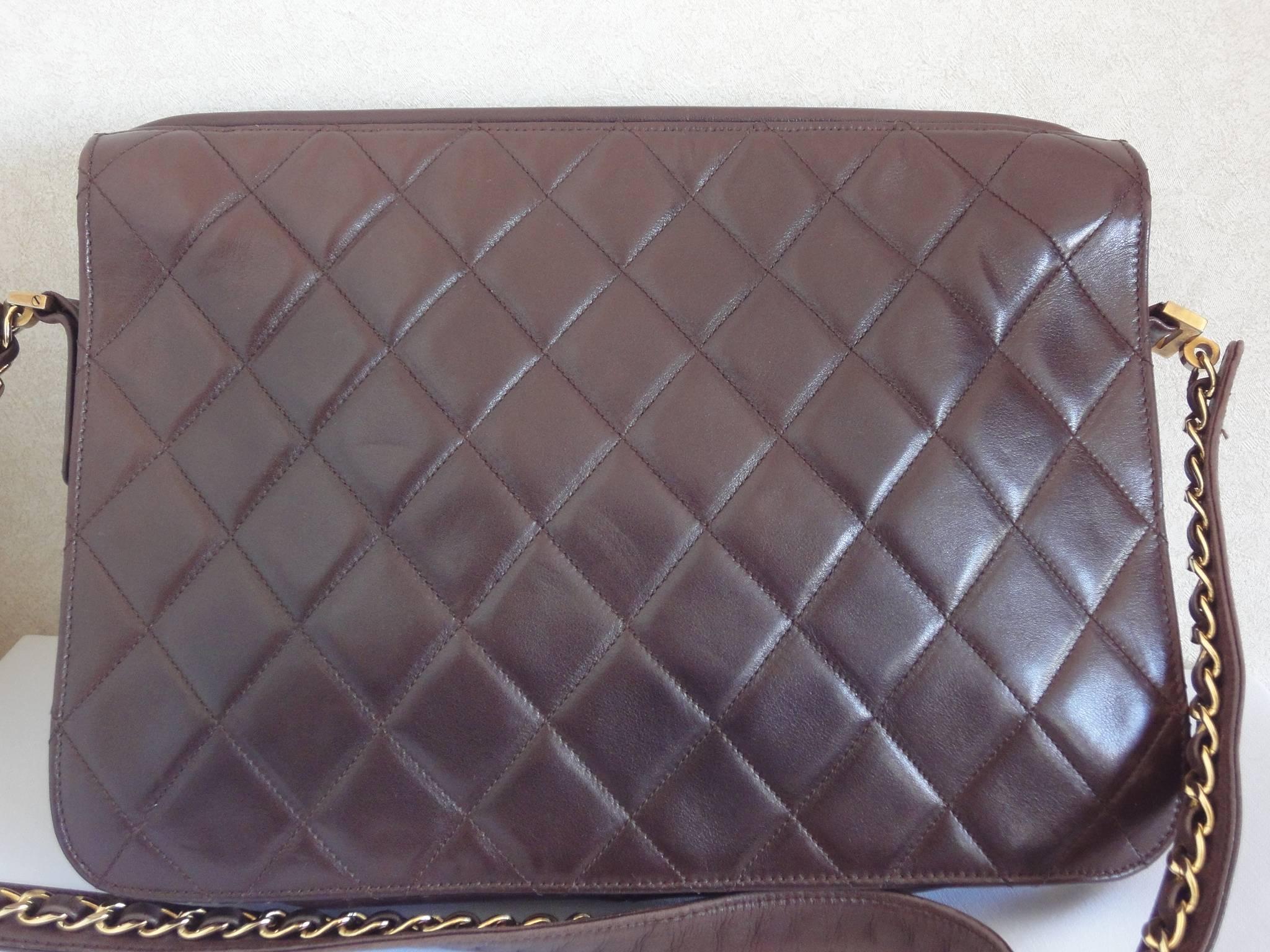 80's vintage Chanel dark brown quilted lambskin shoulder bag with CC motif and built-in chain shoulder strap. Rare Chanel purse.

Introducing one-of-a-kind vintage purse from Chanel in the 80s. 
Darkbrown lambskin square purse with gold tone CC