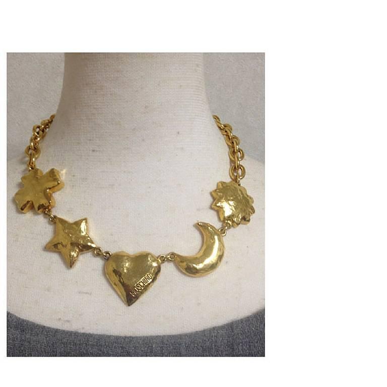 MINT. Vintage Moschino chain statement necklace with large golden heart mark, moon, star, sun, and cross, clover charms. Moschino BIJOUX

Introducing another rare and fabulous jewelry necklace from MOSCHINO, BIJOUX collection back in the 90's.
It