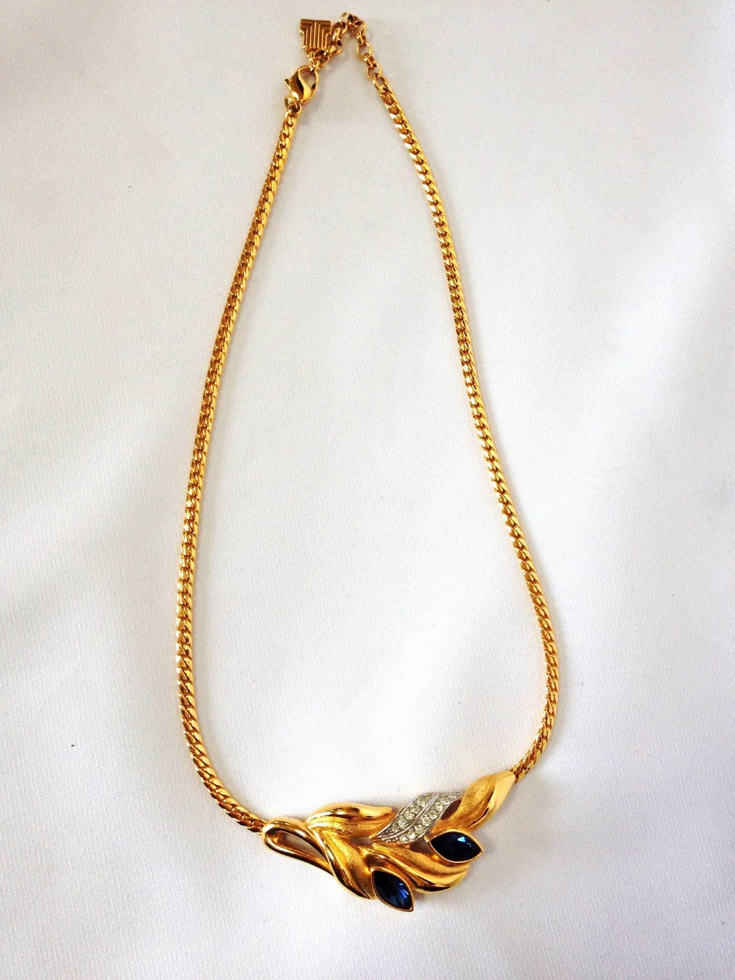 Vintage LANVIN golden chain skinny necklace with golden leaf motif pendant top with clear and navy crystal stones. Perfect jewelry gift.

This is a MINT, excellent vintage gold-tone chain necklace with leaf design pendant top from LANVIN back in