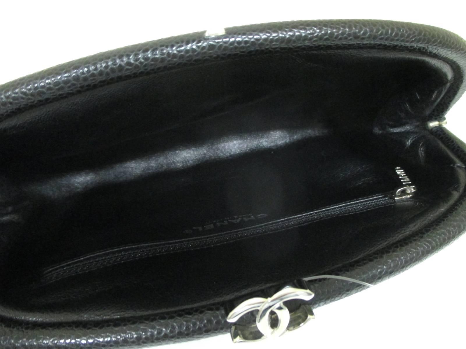 Black Vintage CHANEL kiss-lock closure large black caviarskin clutch bag. Silver cc