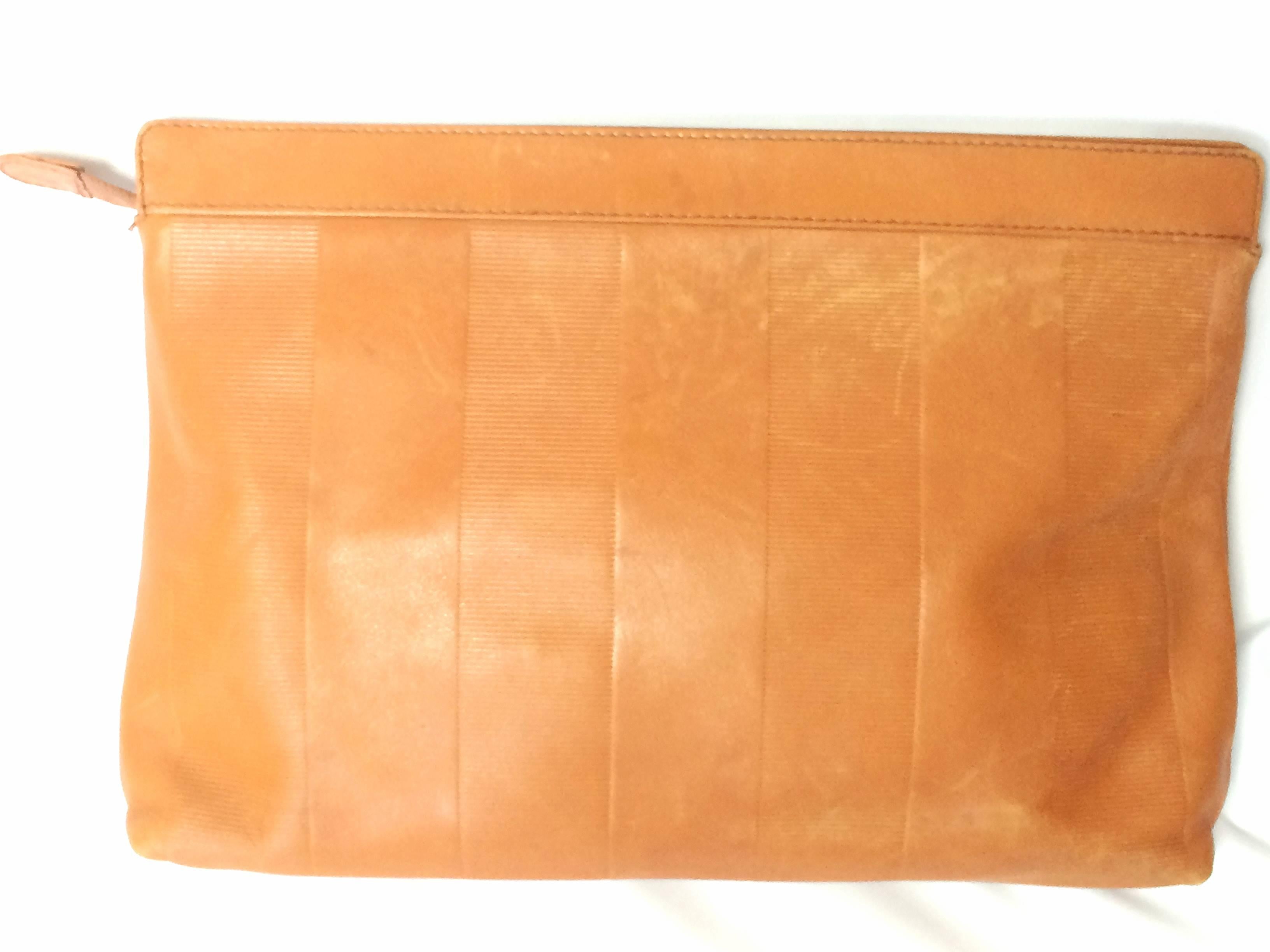 1980s. Vintage Fendi orange brown genuine leather mini document bag, clutch purse with embossed logo and epi mix. Classic unisex style Fendi purse.

This is a vintage classic design orange brown leather clutch bag, mini document purse from FENDI