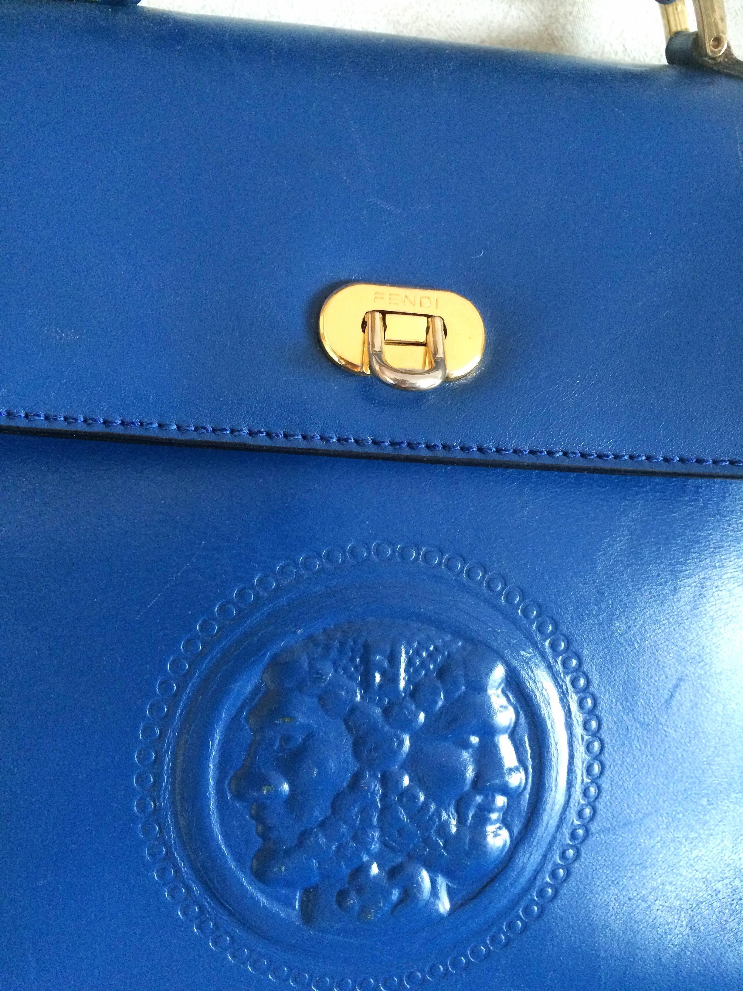 1990s. Vintage FENDI blue leather classic kelly style handbag with iconic Janus medallion embossed motif at front.

For all FENDI vintage lovers, this unique and rare vintage masterpiece is right for you!
Classic Kelly bag style purse in blue