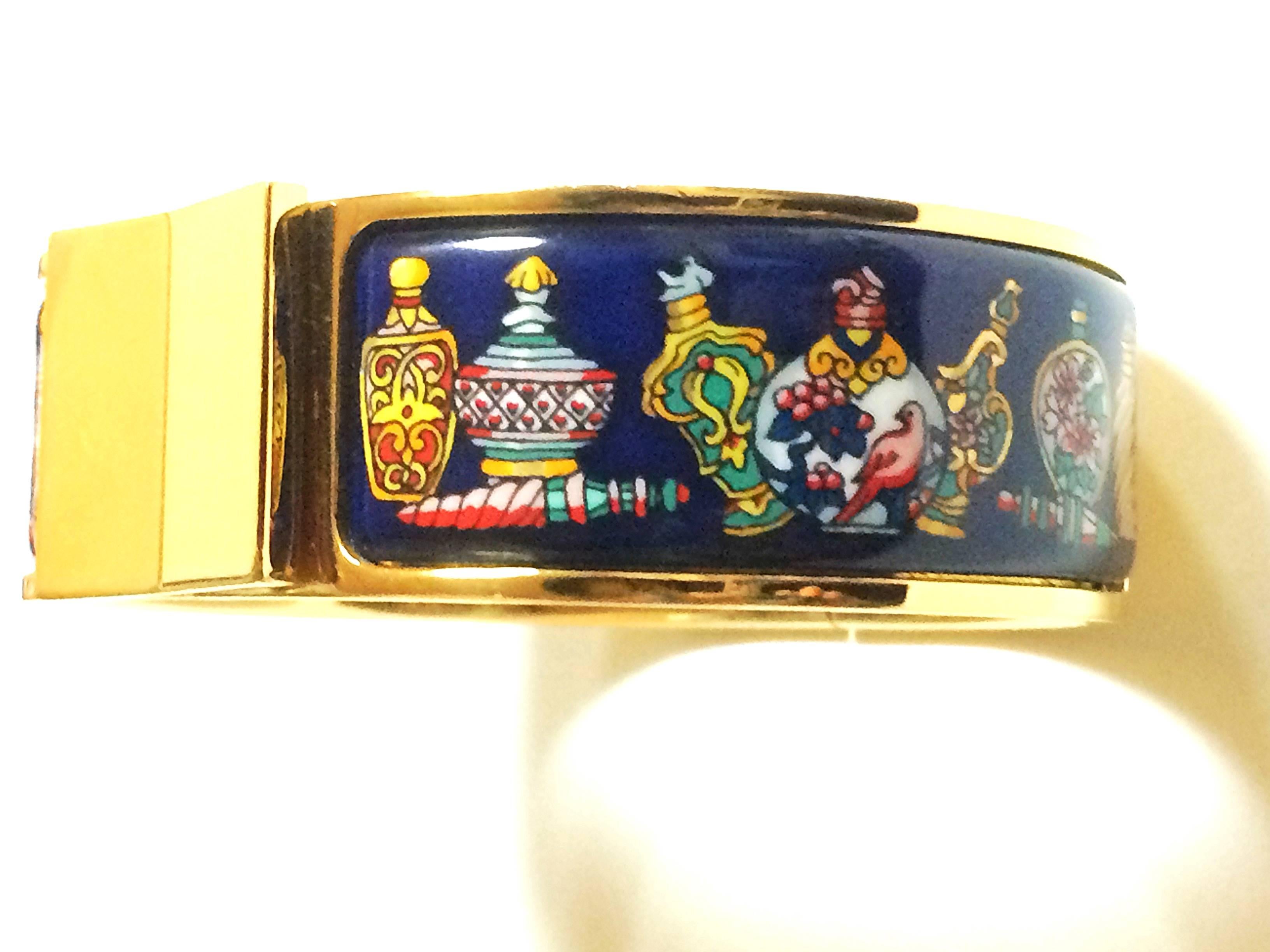 1990s.Vintage Hermes cloisonne enamel golden click and clack Flacon bangle with navy blue and colorful perfume bottle design. Great gift idea.

Fabulous bangle in HERMES's iconic cloisonne enamel.
Excellent beauty and elegance with with navy blue