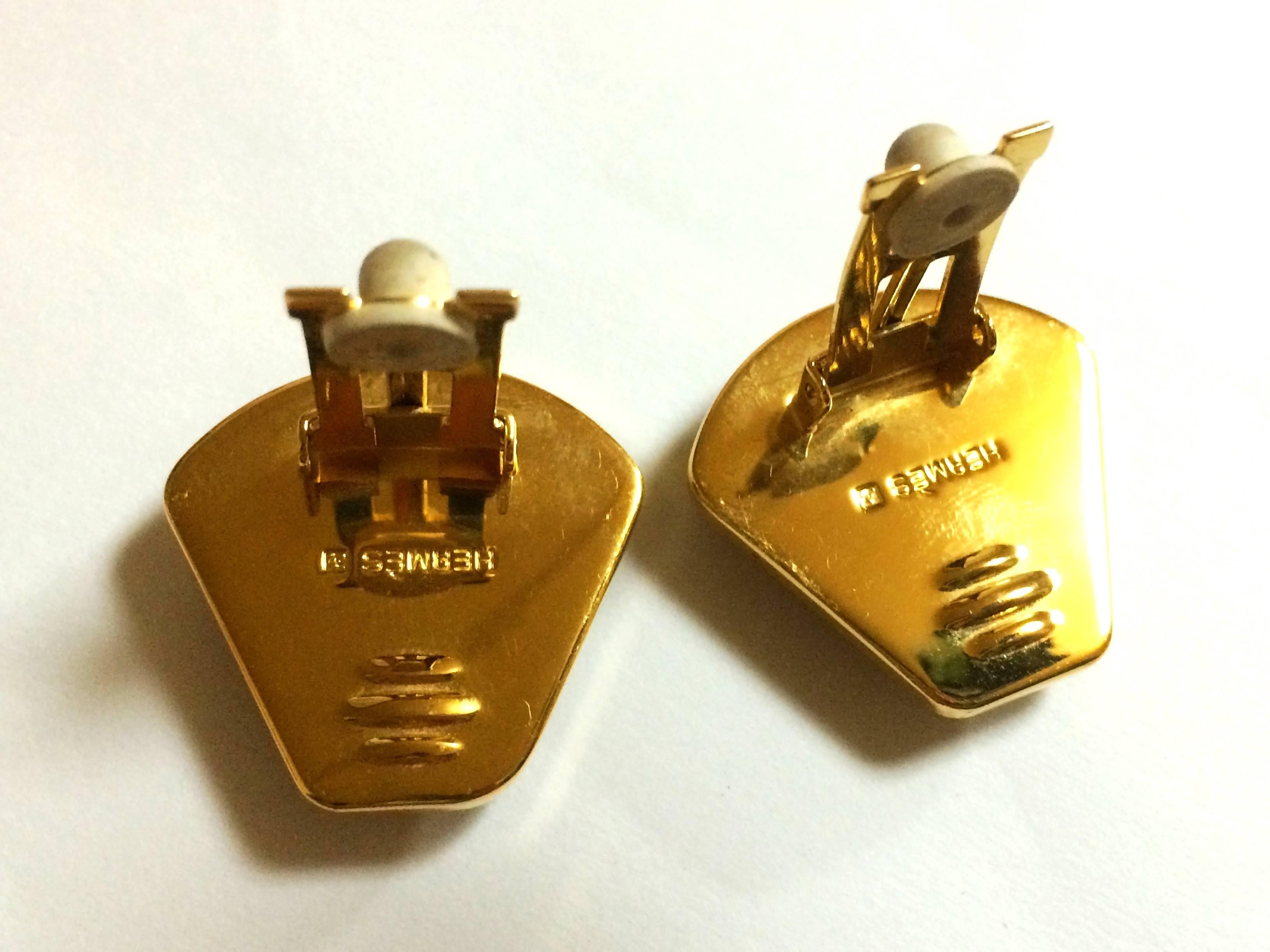 Women's Vintage Hermes cloisonne golden earrings with colorful perfume bottle design.
