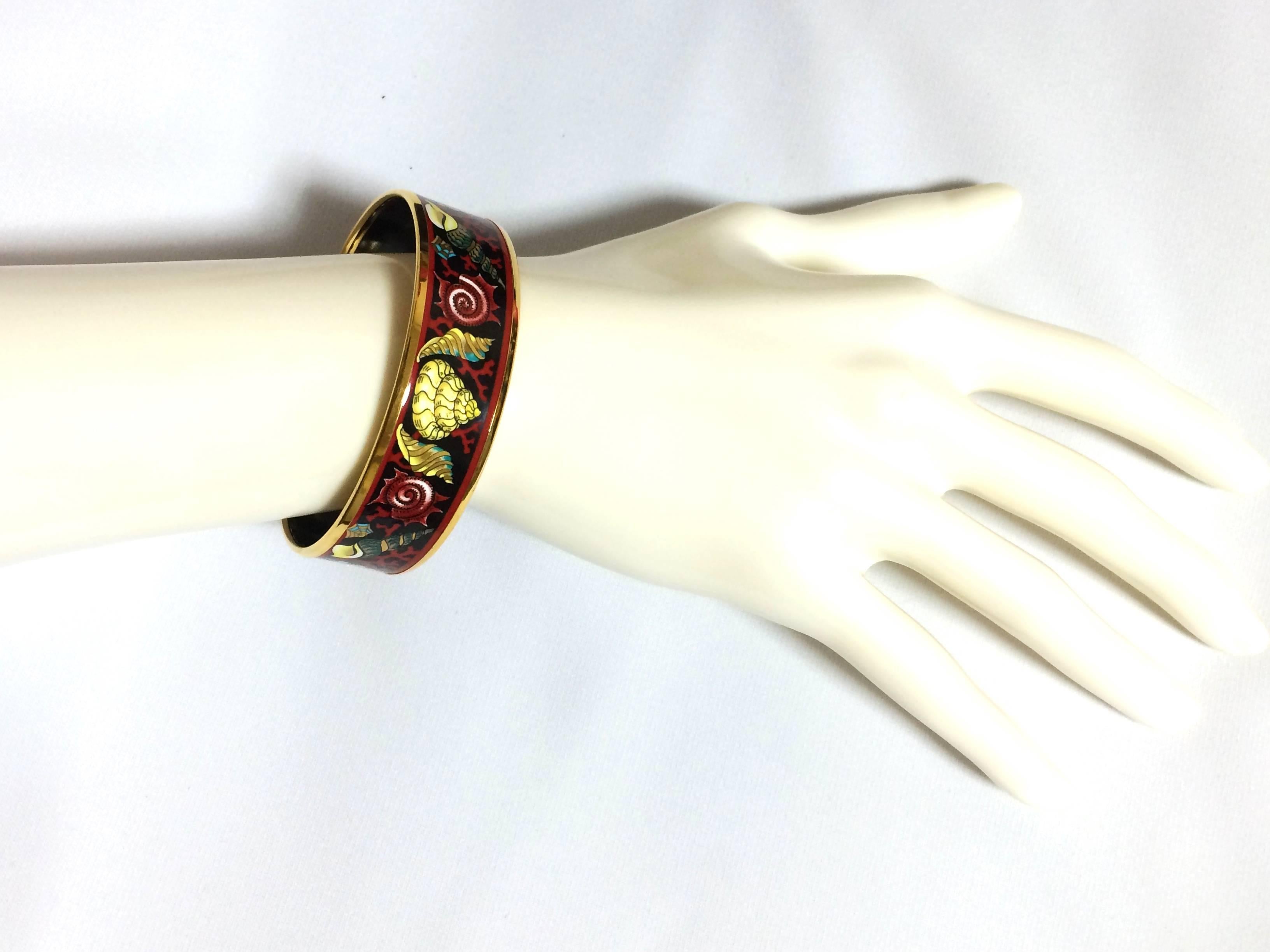1990s. Vintage Hermes cloisonne enamel golden thick bangle, bracelet  with ocean, black sea, red, gold, blue colorful shell, red coral design.

**The same design in blue and pink version is also on sale.**
***Matching earrings are also for