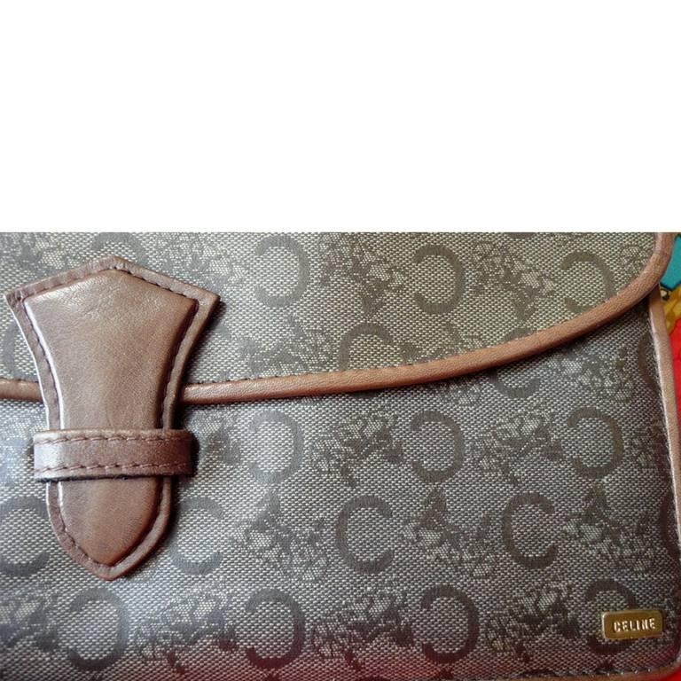 1980s. Vintage CELINE brown beige traditional C and horse and carriage pattern clutch purse, mini document case with leather trimmings.

This is a vintage envelop style brown beige clutch purse from CELINE.
You will love its traditional